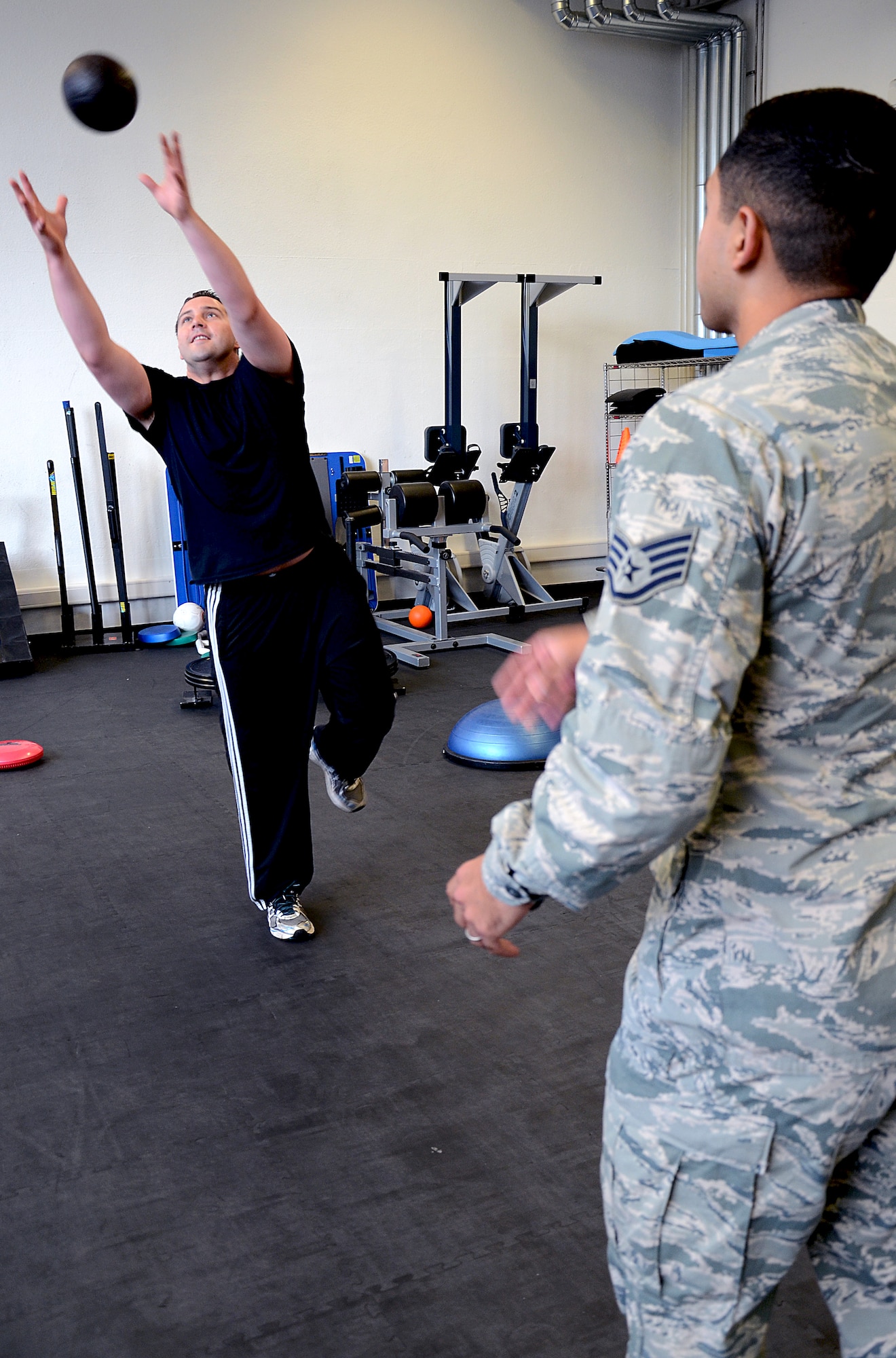 Senior Airman James Harrod, 693rd Intelligence, Surveillance and Reconnaissance Group operations training manager, catches a weighted ball from Staff Sgt. Mario Jimenez, 86th Medical Operations Squadron Physical Therapy technician, during a physical therapy session at Ramstein Air Base, Germany, Aug. 19, 2014. The 86th MDOS physical therapy clinic can see active duty patients for a variety of neuromuscular injuries such as sprains, strains, rehabilitation after the healing of a fracture and many more. (U.S. Air Force photo/Senior Airman Timothy Moore)