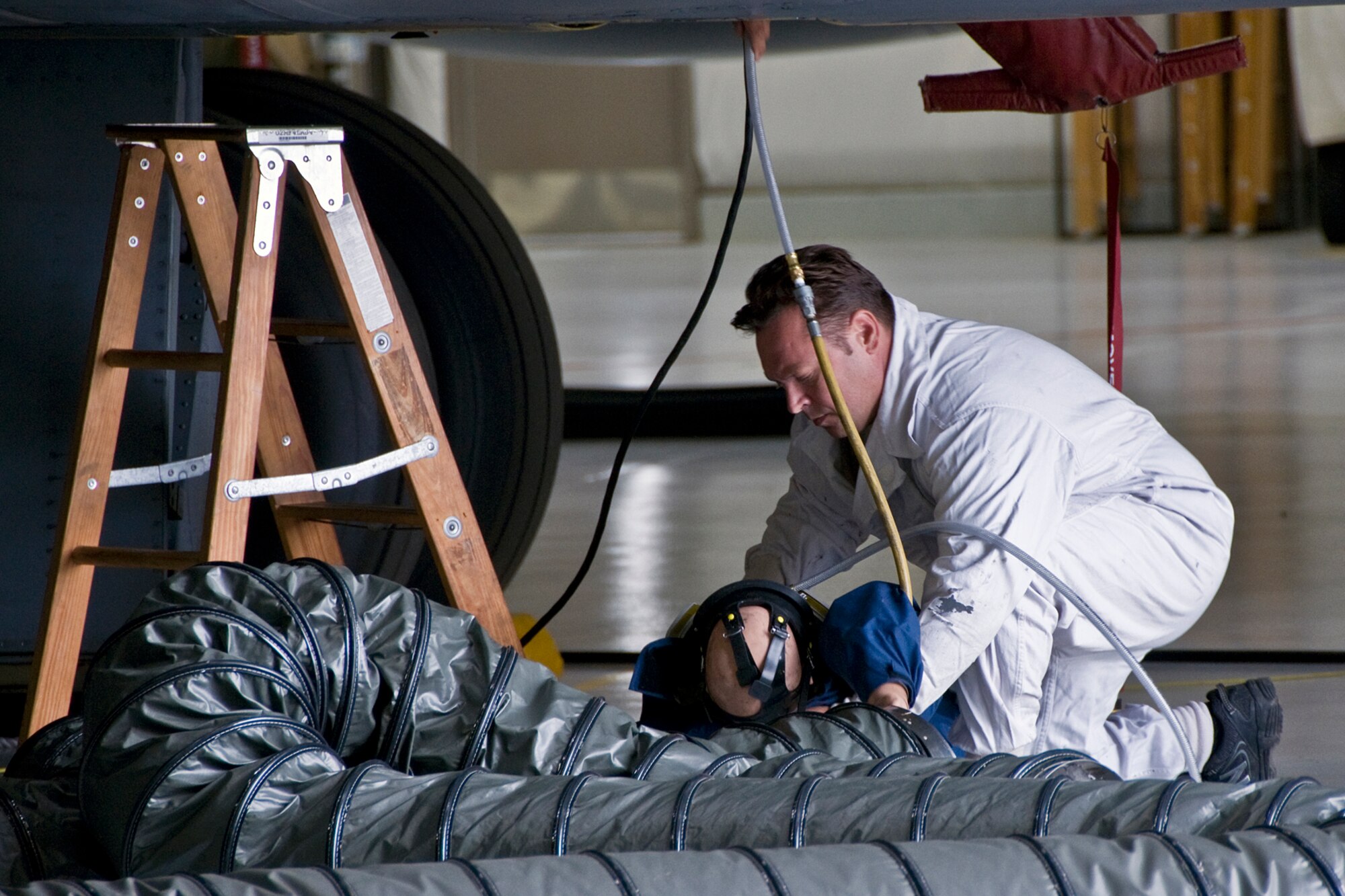 Tech. Sgt. Christopher Mollison, 434th Maintenance Squadron fuel cell systems craftsman, begins self aid and buddy care on a simulated patient during a fuel-cell extraction exercise at Grissom Air Reserve Base, Ind., Aug. 10, 2014. The purpose of the extraction is to ensure that maintenance personnel are able to properly follow their response plan and effectively remove an incapacitated or unconscious person from a KC-135 Stratotanker fuel tank. (U.S. Air Force photo/Staff Sgt. Ben Mota)