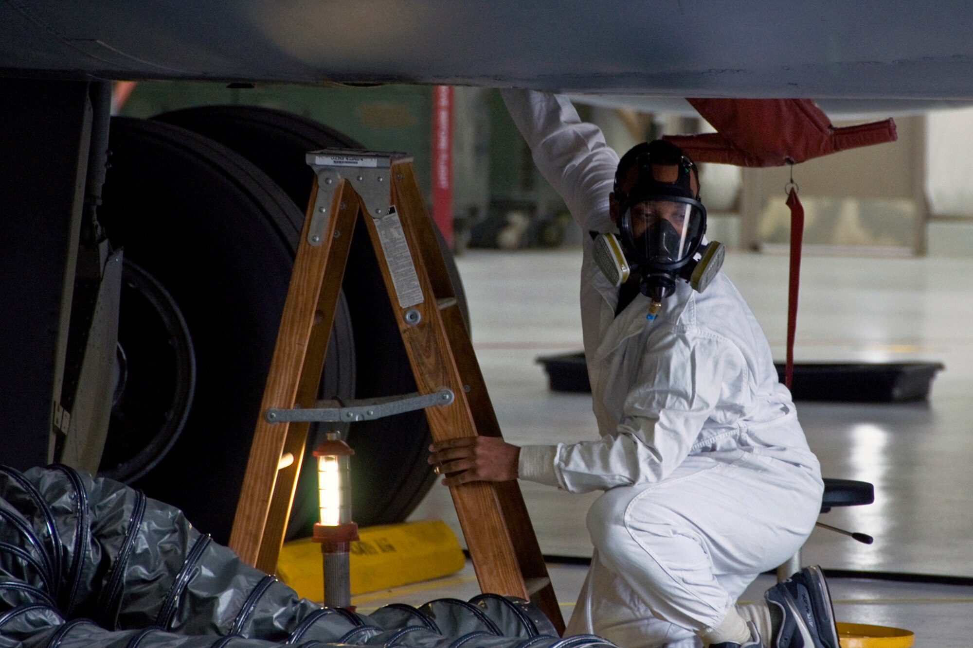 Senior Airman Ryan Reese, 434th Maintenance Squadron fuel-cell systems craftsman, places a photo ionization detector inside a fuel cell of a KC-135 Stratotanker during a fuel cell-extraction exercise at Grissom Air Reserve Base, Ind., Aug. 10, 2014. A PID is used to determine if the air inside a fuel cell is safe for rescuers to enter. (U.S. Air Force photo/Staff Sgt. Ben Mota)