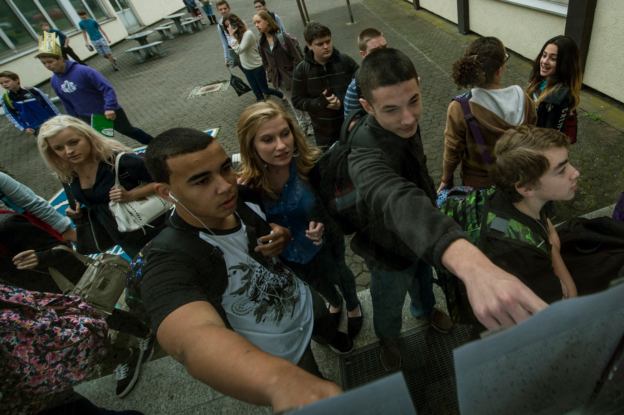 Students from Bitburg Middle-High School check who their seminar teacher will be during the first day of school Aug. 25, 2014, at Bitburg Annex, Germany. The seminar class provides students a study hour during the week. (U.S. Air Force photo by Senior Airman Rusty Frank/Released)