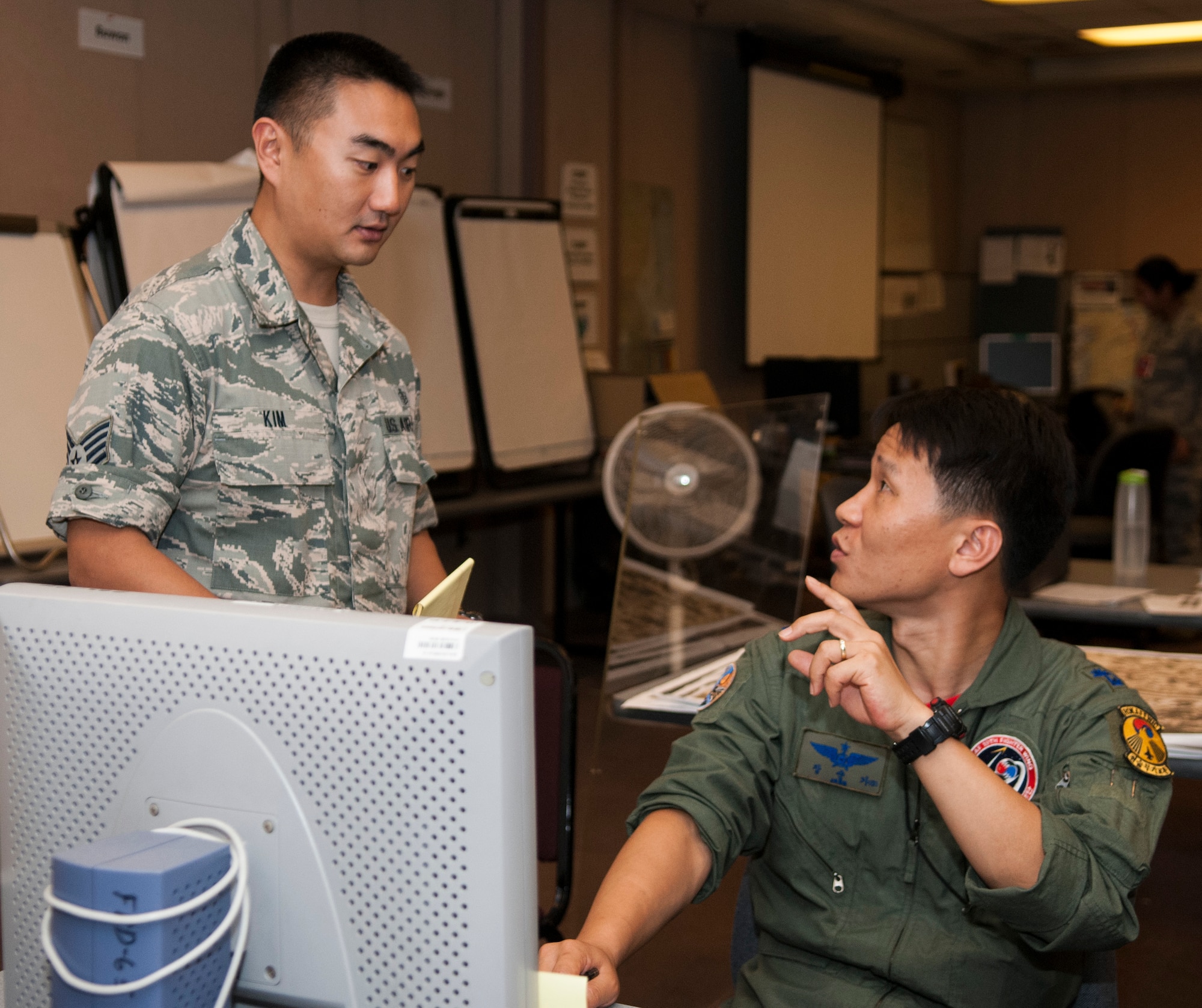 Staff Sgt. Jonghwan Kim, Ulchi Freedom Guardian translator, listens and interprets what Maj. Soon Ki Jang, Joint Forces Military University member, says at Osan Air Base, South Korea, during UFG, Aug. 21, 2014. Kim scored well on the Korean Defense Language Proficiency Test, which led him to an opportunity of breaking through translation barriers between the U.S. and Republic of Korea forces. (U.S. Air Force photo by Senior Airman Racheal E. Watson/Released)