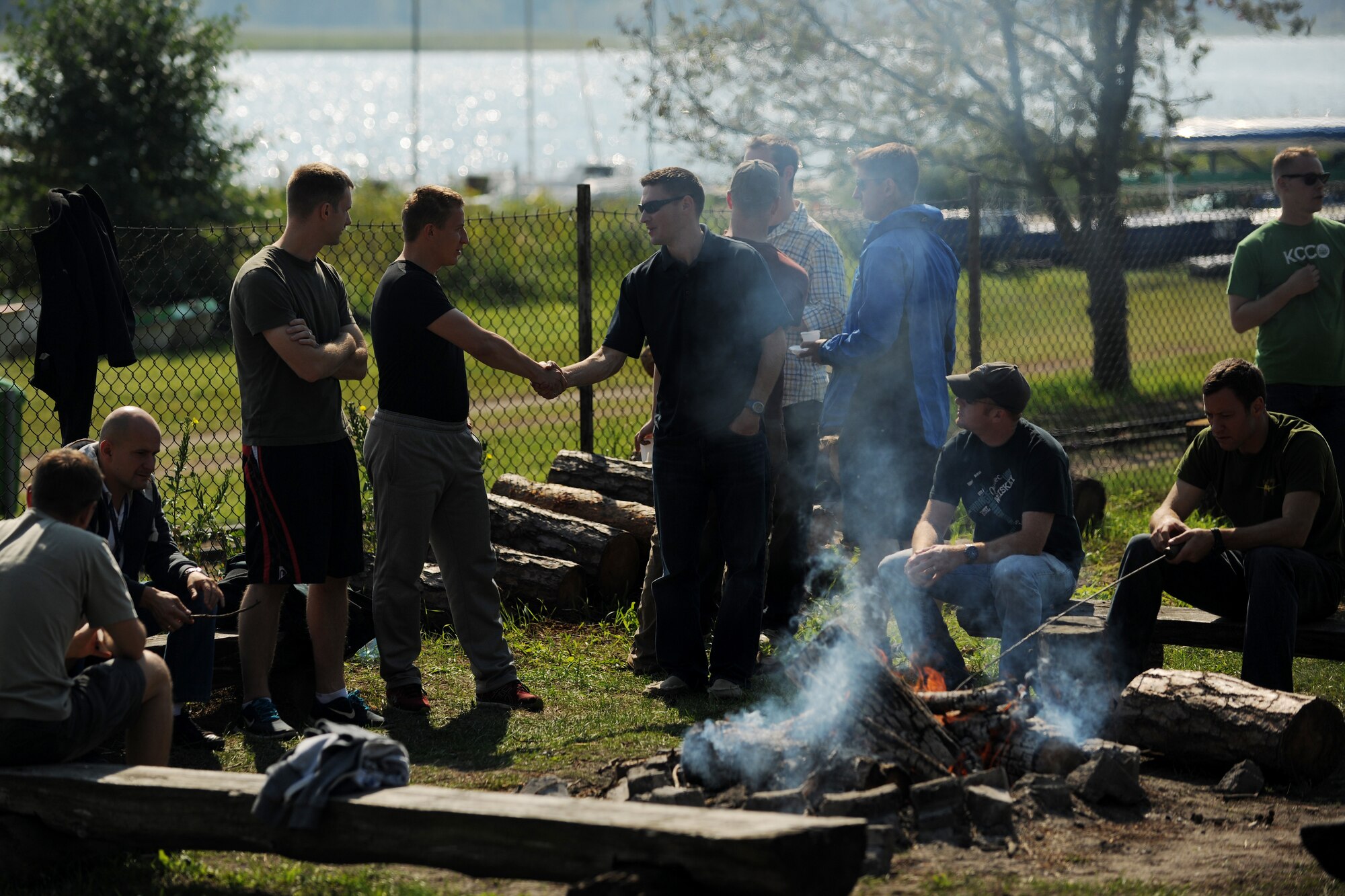 U.S. Air Force Airmen and Polish Army soldiers swap stories during a barbecue at Powidz Lake, Poland, Aug. 22, 2014. The bilateral event allowed Service members from both nations to learn more about one another and strengthen the already-existing bonds of friendship. (U.S. Air Force photo by Staff Sgt. Jarad A. Denton/Released)