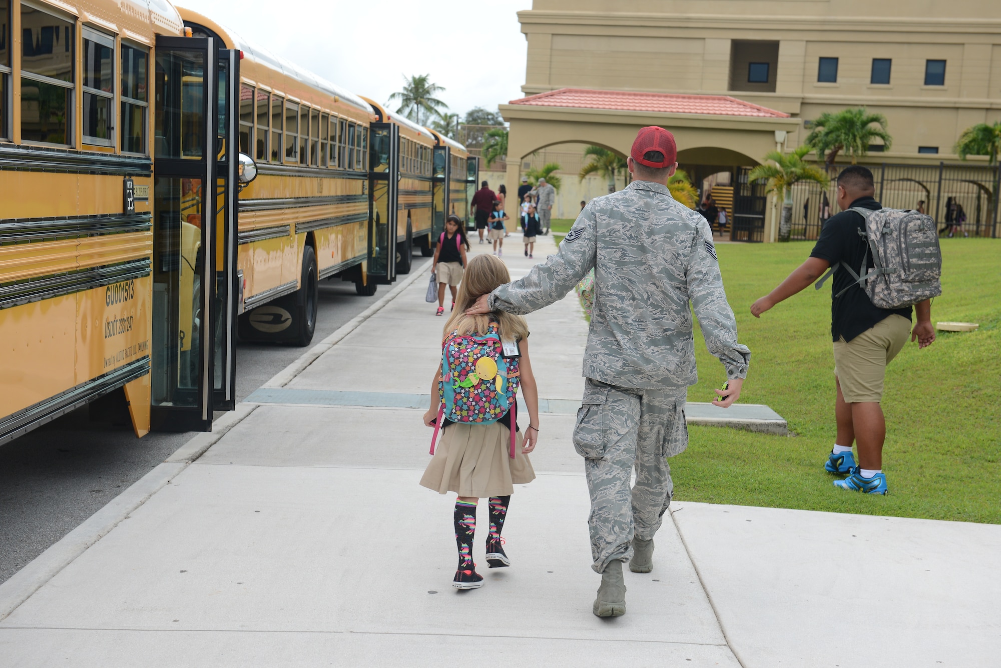 An Airman from the 554th Red Horse Squadron picks up his daughter from Andersen Elementary School Aug. 25, 2014, on Andersen Air Force Base, Guam. Today was the students’ first day back from summer break.  (U.S. Air Force photo by Airman 1st Class Adarius Petty/Released)
