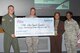 (Right to left) Capt. Twana Hadden, 374th Medical Group, and Tanya Powell, Pacific Command Combined Federal Campaign-Overseas campaign manager, present Col. Douglas DeLaMater, 374th Airlift Wing commander, and Chief Master Sgt. Jason Williams, 374th Operations Group, the CFC-O fiscal year 2014 check at Yokota Air Base, Japan, Aug. 25, 2014. The check, a sum of $19,927, is a collection of undesignated CFC-O donations from service members and federal employees from Yokota and will be used towards Family Support and Youth Programs. (U.S. Air Force photo by Osakabe Yasuo/Released)