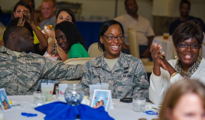 Spectators watch Joint Base Charleston's AMC Icon competition Aug. 21, 2014, at the Charleston Club. Each major installation within AMC is conducting a base-level AMC Icon contest. AMC Icon is held each year to promote morale and healthy competition across the command. (U.S. Air Force photo/Staff Sgt. William O'Brien)