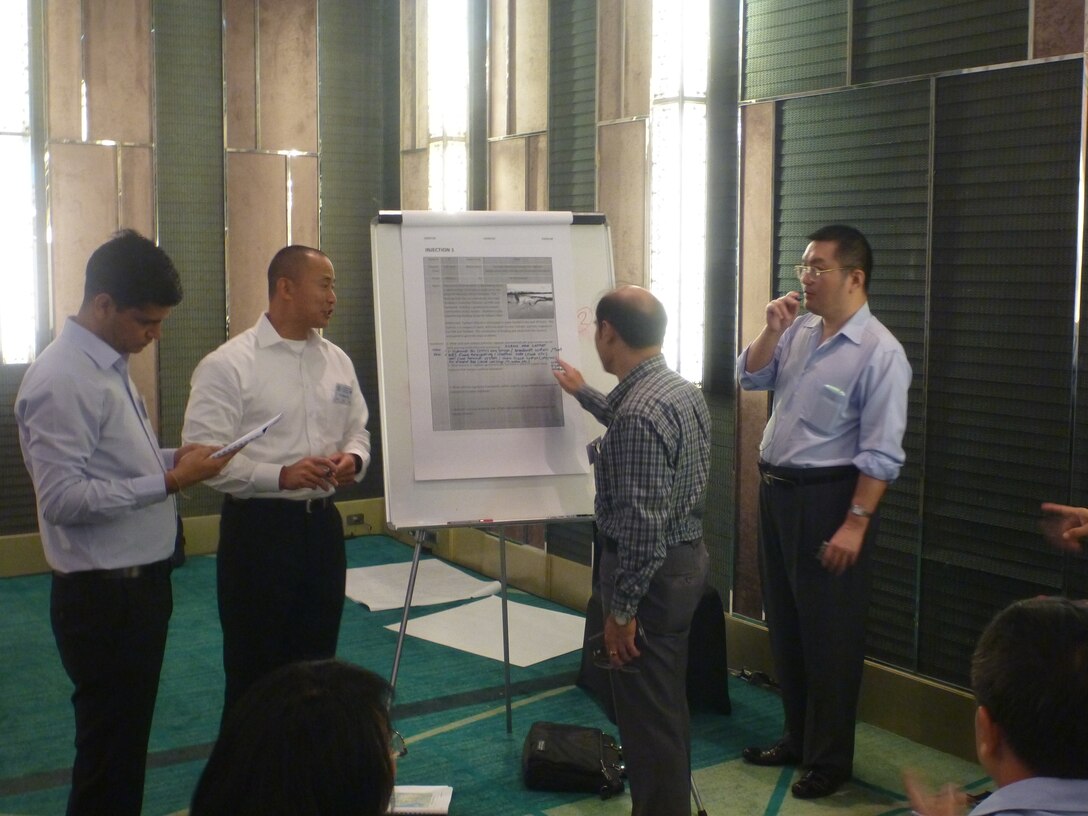 LTC Evan Ting, U.S. Army Corps of Engineers, works with representatives from the Mekong River Commission and Asian Disaster Preparedness Centre to respond to an exercise question. 