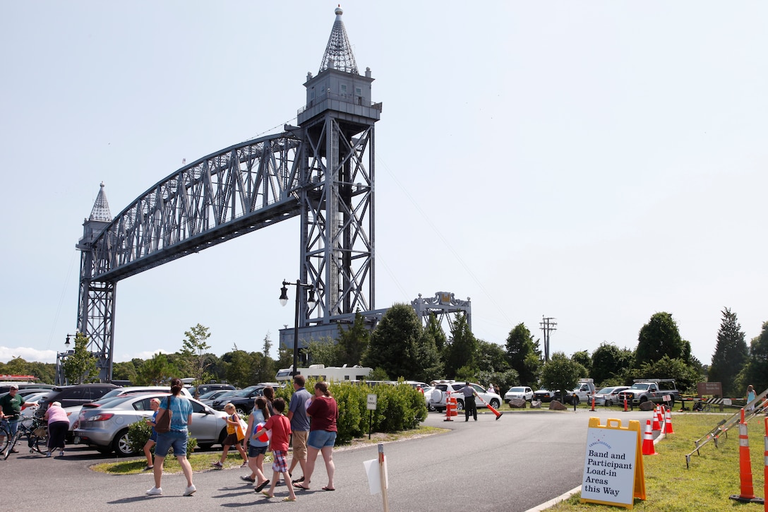 Participants walk past the Cape Cod Canal Railroad Bridge to get to the centennial celebration at Buzzards Bay Park in Bourne, Mass.