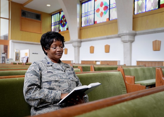 Chaplain (Lt. Col.) Donnette Boyd reads a Bible Aug. 18, 2014, in the pews of the base chapel at Aviano Air Base, Italy. Boyd commissioned into the military in 1987 with no initial intentions of becoming a chaplain. After her experience with three spiritual calls, becoming a chaplain became clear in her future in the Air Force. Boyd is now a 31st Fighter Wing chaplain.  (U.S. Air Force photo/Airman 1st Class Deana Heitzman)