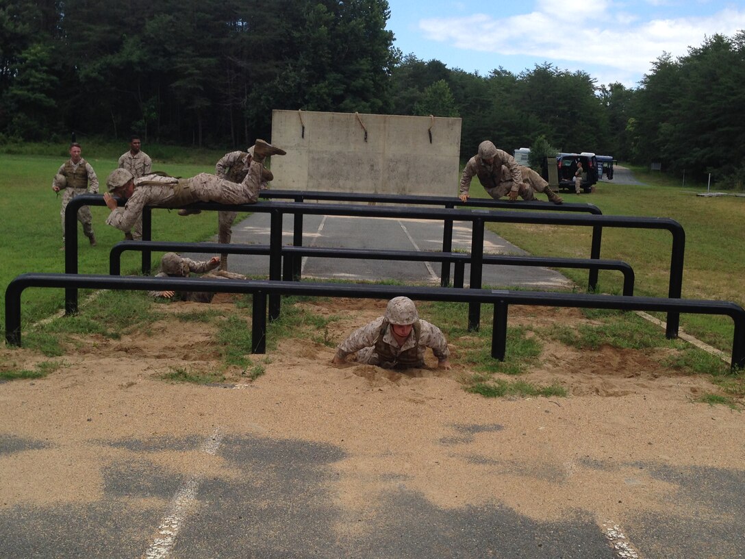 Marines from 3rd Platoon, Company B, Marine Barracks Washington, D.C., compete against each other on a NATO obstacle course during a training exercise at Marine Corps Base Quantico, Aug. 13, 2014. The "Third Herd" traveled to Marine Corps Base Quantico to conduct a field exercise focused on land navigation and combat conditioning.