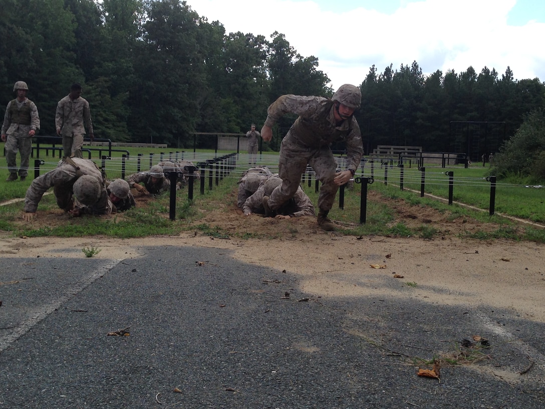 Marines from 3rd Platoon, Company B, Marine Barracks Washington, D.C., compete against each other on a NATO obstacle course during a training exercise at Marine Corps Base Quantico, Aug. 13, 2014. The "Third Herd" traveled to Marine Corps Base Quantico to conduct a field exercise focused on land navigation and combat conditioning." 