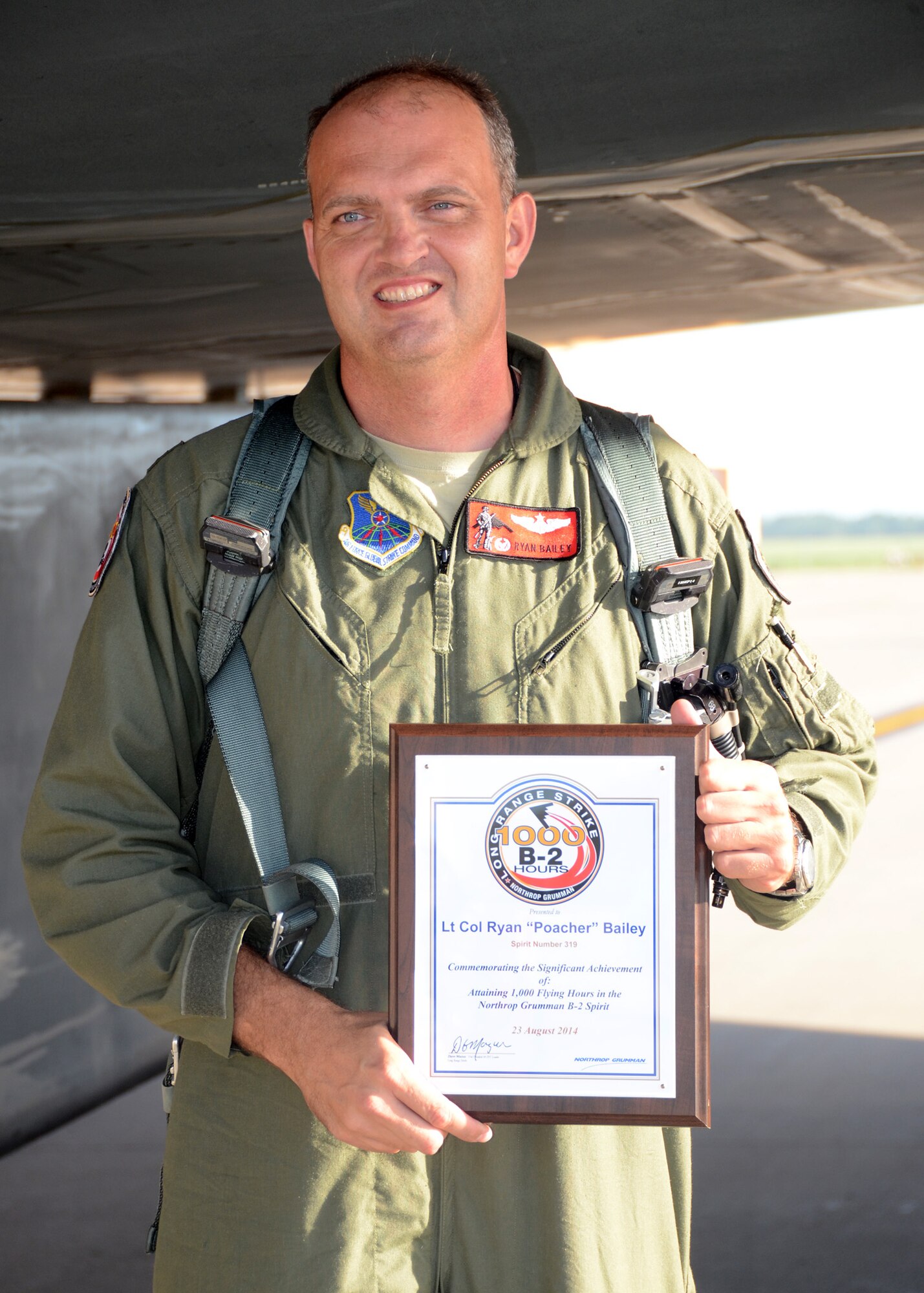 B-2 Spirit pilot Lt. Col. Ryan Bailey, 131st Bomb Wing, Missouri Air National Guard, shows the certificate of achievement recognizing his 1000 flying-hour milestone at the end of a B-2 training mission at Whiteman Air Force Base, August 23, 2014. (U.S. Air National Guard photo by Staff Sgt. Brittany Cannon)
