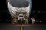 An SUV belonging to New York Task Force 1, New York City's FEMA sponsored urban search and rescue team is loaded on a C-17 belonging to the 21st Airlift Squadron from Travis Air Force Base California by Airmen of the 105th Airlift Wing's Logistics Squadron early Saturday morning, Jan. 16. The New York Air National Guard's 105th Airlift Wing provided support to the team as they deployed to Port-au-Prince to respond to the Haiti Earthquake.