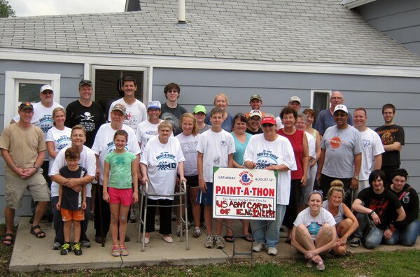 Homeowners Erich and Arlene Schwartz stand among just a couple dozen of the more than 67 volunteers from within the Omaha District Corps of Engineers, along with their family members, who donated their time, talents, and giving generosity to this year’s Paint-A-Thon 2014.