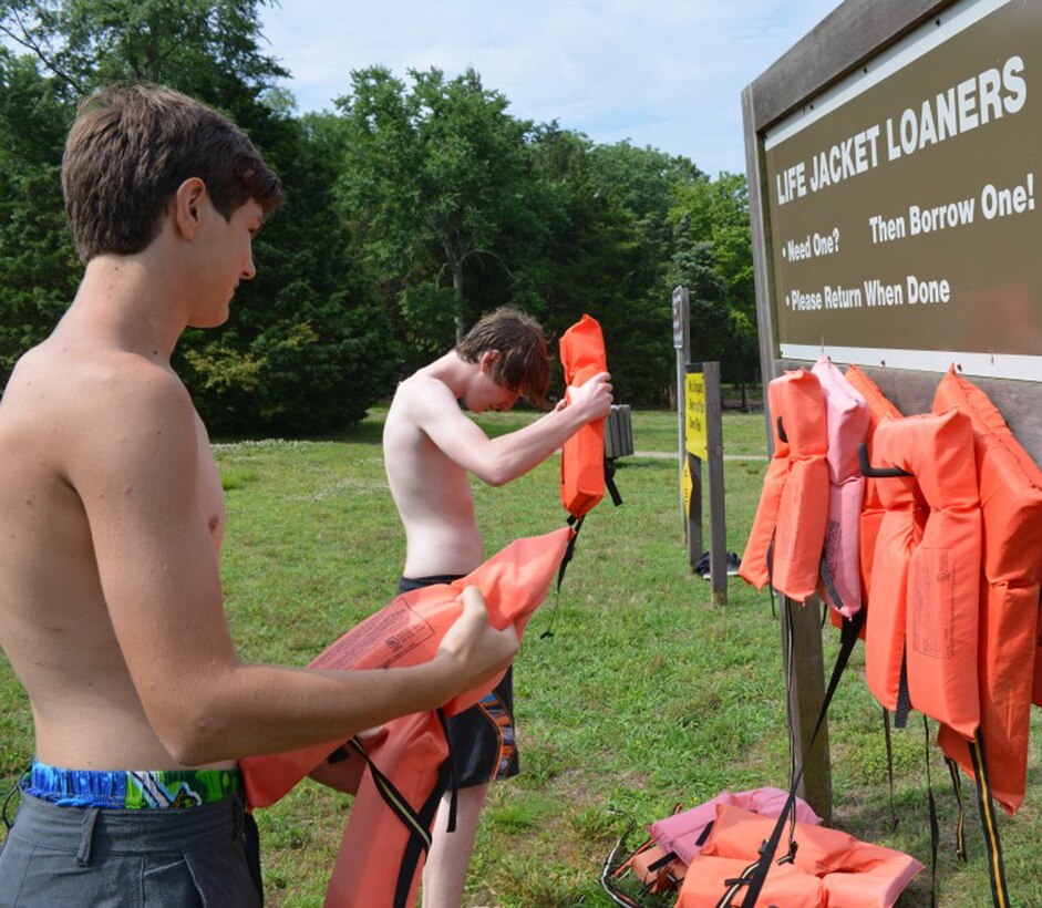 ASHLAND, Tenn. (June 16, 2014) – Two young swimmers borrow life rings from the Life Jacket Loaner board at the Cheatham Dam beach area.  The life jacket loaner board is used for anyone who needs to borrow a life vest.  Before heading out for the lake or river, be sure you have a life jacket on hand for everyone. Check that the life jackets are U.S. Coast Guard approved, are the right size, the right fit, and are appropriate for the activity you have planned. Then please make sure everyone wears it. Life jackets save lives by keeping you afloat and providing time for rescue.
  