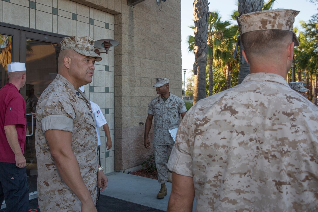 Master Sgt. Johnny Sandoval, food service technician and staff noncommissioned officer in charge of Gonzales Hall, greets inspectors for the Best of the West competition aboard Marine Corps Air Station Miramar, Calif., Aug. 26. The air station’s mess hall competed in and won the competition in fiscal years 2012, 2013, 2014, and hopes to regain the title for 2015.