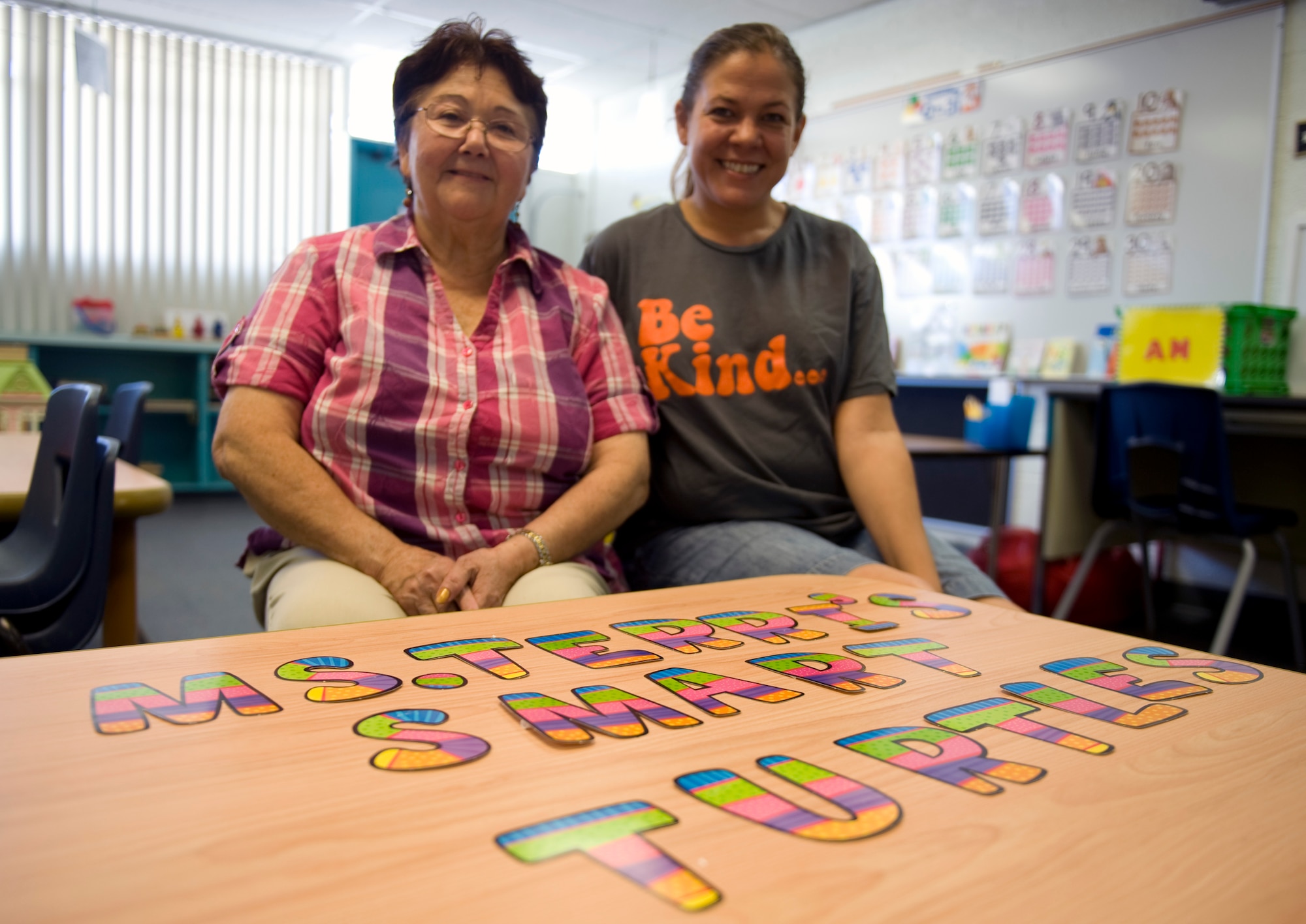 Dominga Romero (left), special program teacher assistant, and Terri Gravnitz (right), early childhood special education teacher, smile with excitement for the start of the new school year at Lomie G. Heard Elementary School on Nellis Air Force Base, Nev., Aug. 21, 2014. The new school year will encourage students to grow, strive harder, as well as building good character and provide a safe environment for children to learn. (U.S. Air Force photo by Airman 1st Class Mikaley Towle)