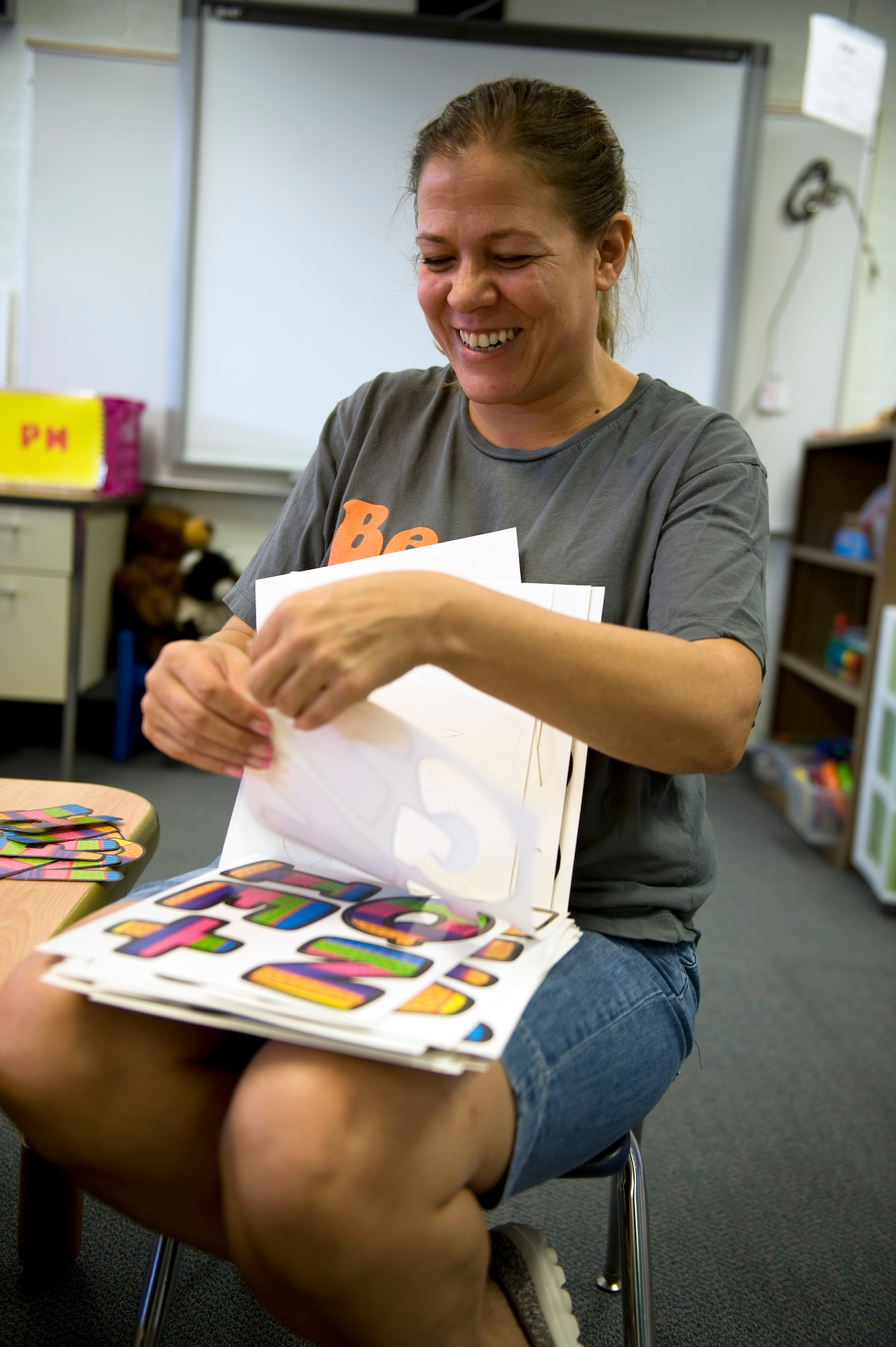 Terri Gravnitz, early childhood special education teacher, decorates her classroom for the new school year at Lomie G. Heard Elementary School on Nellis Air Force Base, Nev., Aug. 21, 2014. For Gravnitz’ class, the upcoming school year will focus on encouraging good behavior, as well as recognizing anyone maintaining a good attitude.(U.S. Air Force photo by Airman 1st Class Mikaley Towle)