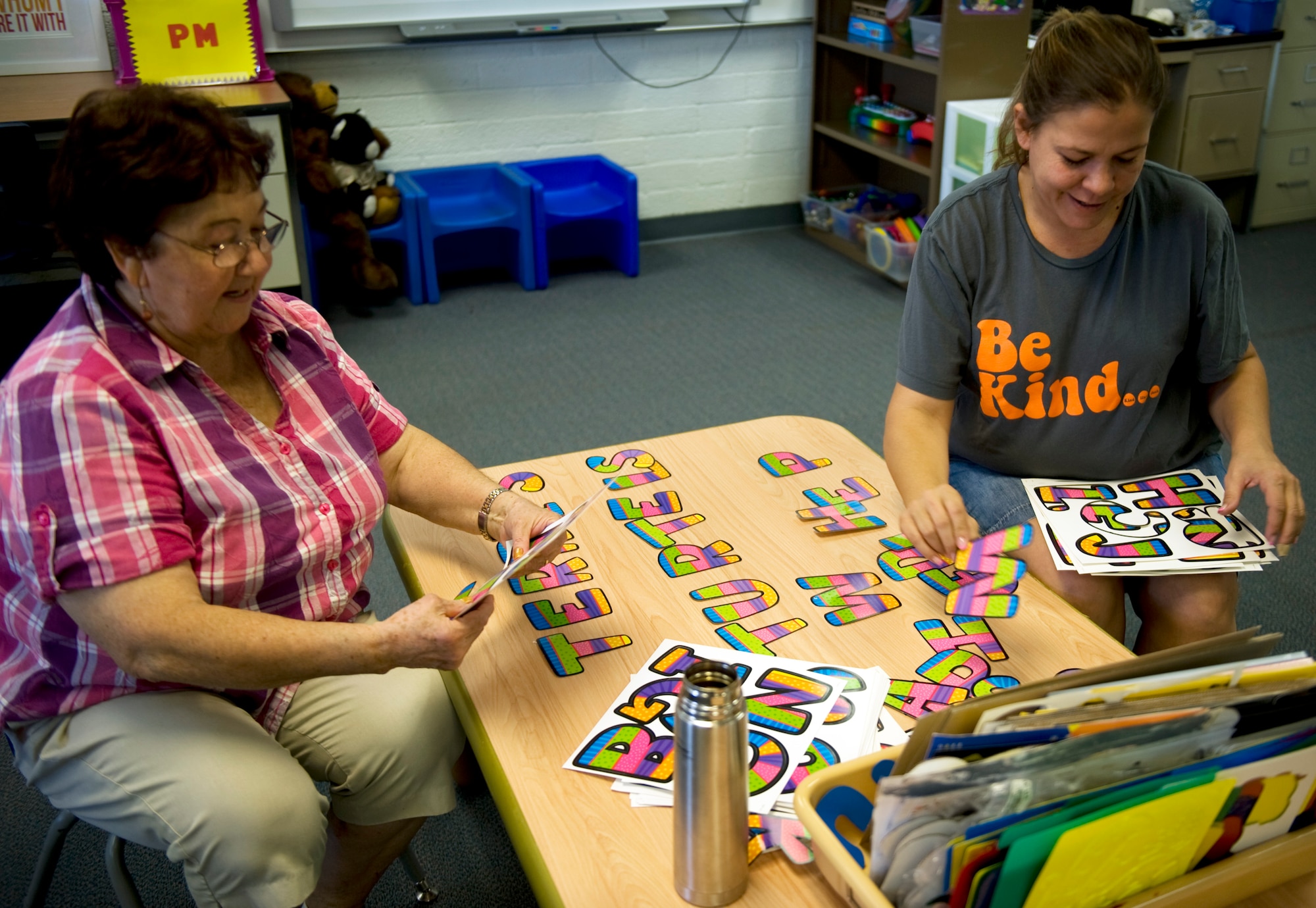 Dominga Romero (left), special program teacher assistant, and Terri Gravnitz (right), early childhood special education teacher, organize letters for their classroom at Lomie G. Heard Elementary School on Nellis Air Force Base, Nev., Aug. 21, 2014. Every Wednesday, children in Gravnitz’ class will be recognized for performing acts of kindness and given a classroom incentive as a prize. (U.S. Air Force photo by Airman 1st Class Mikaley Towle)