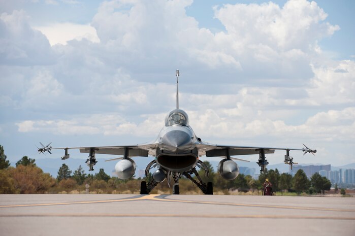 An F-16 Fighting Falcon from the 309th Fighter Squadron, Luke Air Force Base, Ariz., taxis to the runway during Green Flag-West 14-09 at Nellis AFB, Nev., Aug. 21, 2014. Green Flag exercises give visiting units the opportunity to train in air-to-ground combat operations. Many of the training exercise scenarios call for providing air support to ground troops who are participating in ground combat exercises. (U.S. Air Force photo by Airman 1st Class Thomas Spangler)