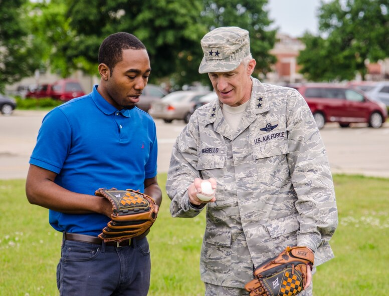 TMCF summer intern Maso Cotton, who also pitched for the Virginia State University baseball team, was able to give a few pointers to AFRL Commander Gen. Thomas Masiello, prior to the commander's ceremonial first pitch for the Dayton Dragons Single-A baseball team. (U.S. Air Force photo/Mikee Huber) 
