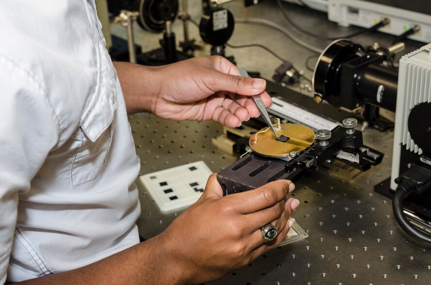 AFRL TMCF summer intern Elijah Blakemore works on a high sensor cell used to measure pyroelectric voltage responses. (U.S. Air Force photo/Mikee Huber) 