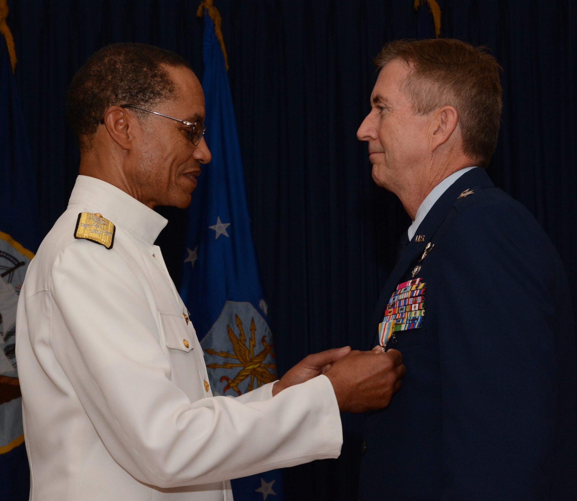 Adm. Cecil D. Haney, U.S. Strategic Command commander, decorates Maj. Gen. William Schauffert, Mobilization Assistant to the USSTRATCOM commander, with the Defense Superior Service Medal during Schauffert's retirement ceremony August 22, 2014, at the Naval Air Station Fort Worth Joint Reserve Base, Texas. USSTRATCOM, located at Offutt Air Force Base, Neb., is one of nine DoD unified combatant commands and is charged with strategic deterrence, space operations, cyberspace operations, joint electronic warfare, global strike, missile defense, intelligence, surveillance and reconnaissance, combating weapons of mass destruction, and analysis and targeting. (U.S. Air Force photo/Staff Sgt. Samantha Mathison)