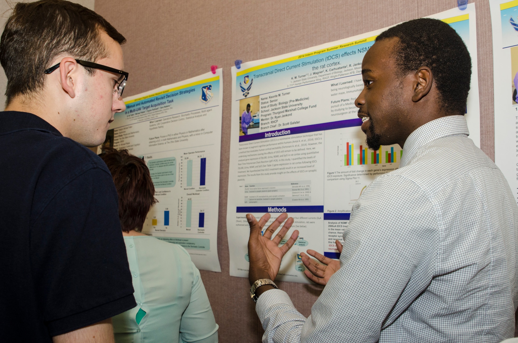 Keonte Turner, Thurgood Marshall College Fund intern at AFRL, discusses his project entitled "The Effect of Transcranial Direct Current Stimulation on Gene Expression in the Rat Cortex." (US Air Force photo/Mikee Huber)