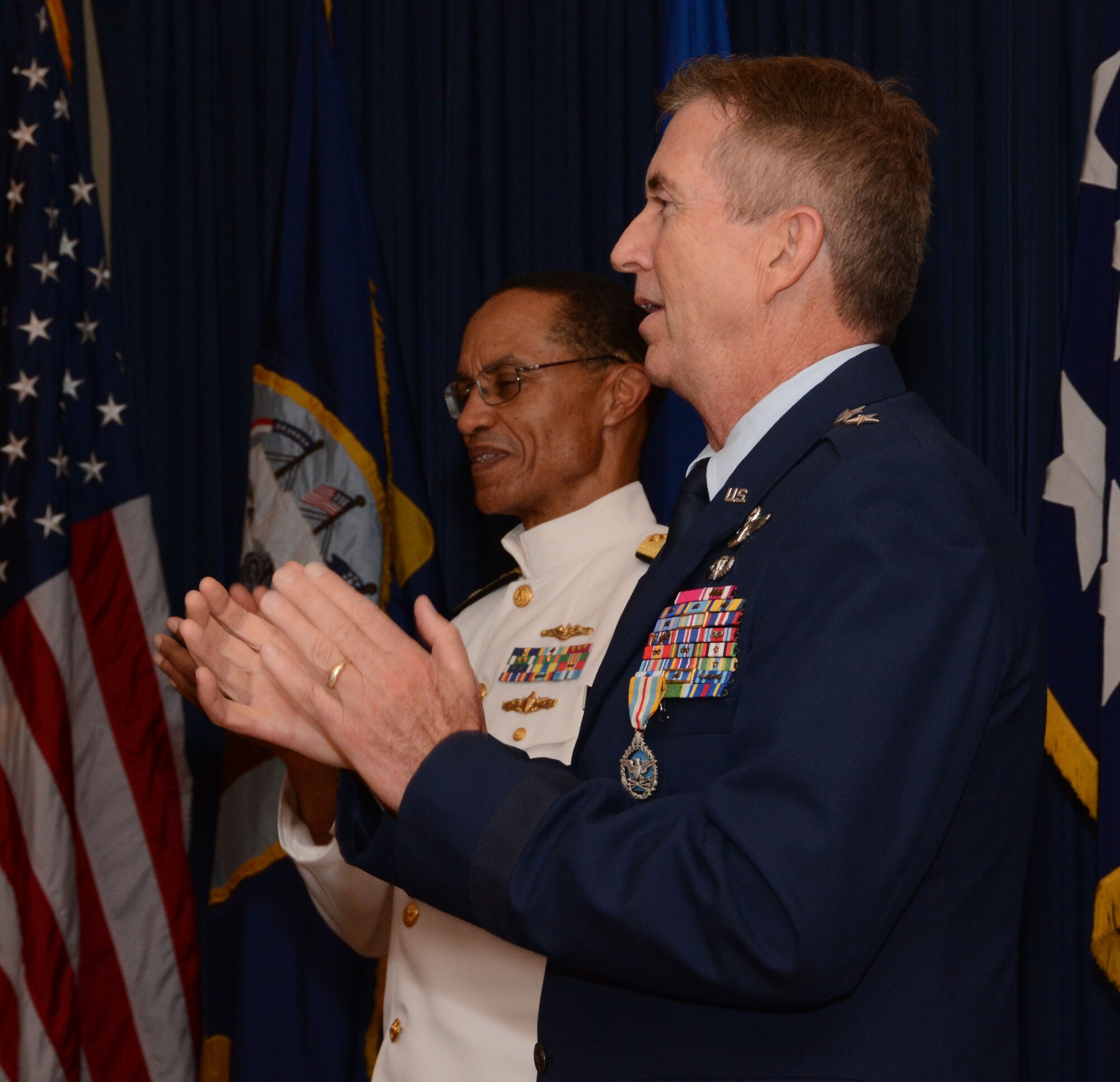 Maj. Gen. (Ret) William Schauffert, former Mobilization Assistant to the U.S. Strategic Command commander, and Adm. Cecil D. Haney, USSTRATCOM commander and officiating officer, sing along to the Air Force song following Schauffert's retirement ceremony. The event was held August 22, 2014, at the Naval Air Station Fort Worth Joint Reserve Base, Texas.  USSTRATCOM, located at Offutt Air Force Base, Neb., is one of nine DoD unified combatant commands and is charged with strategic deterrence, space operations, cyberspace operations, joint electronic warfare, global strike, missile defense, intelligence, surveillance and reconnaissance, combating weapons of mass destruction, and analysis and targeting. (U.S. Air Force photo/Staff Sgt. Samantha Mathison)