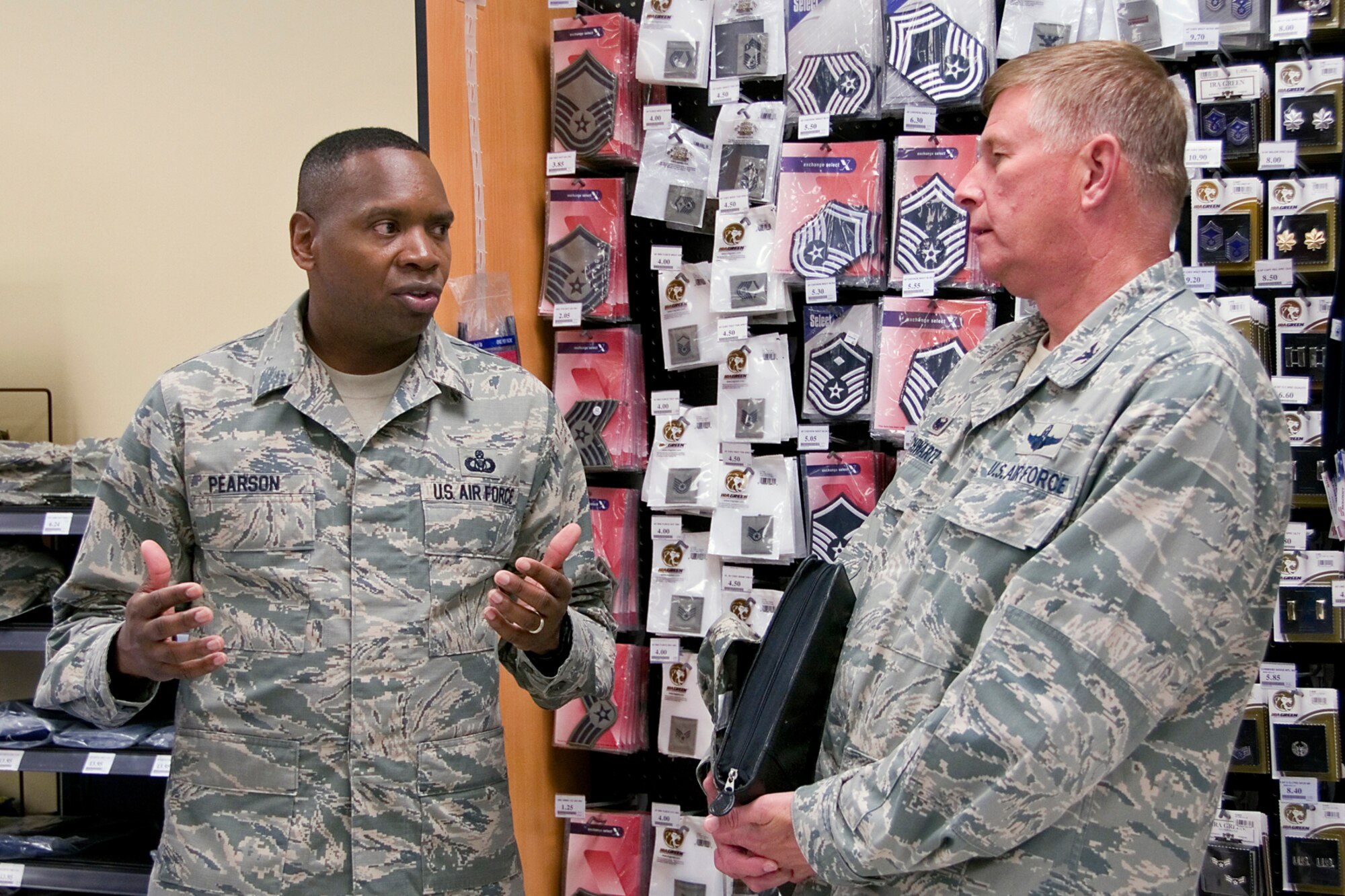 Chief Master Sgt. Anthony Pearson, Army and Air Force Exchange Service senior enlisted advisor, speaks with Col. Doug Schwartz, 434th Air Refueling Wing commander, during the chief's visit to Grissom Air Reserve Base, Ind., Aug. 12, 2014. During Pearson's visit he met with service and community members to addressed AAFES related issues and inform customers of the benefits of shopping at an Exchange. (U.S. Air Force photo/Staff Sgt. Ben Mota)