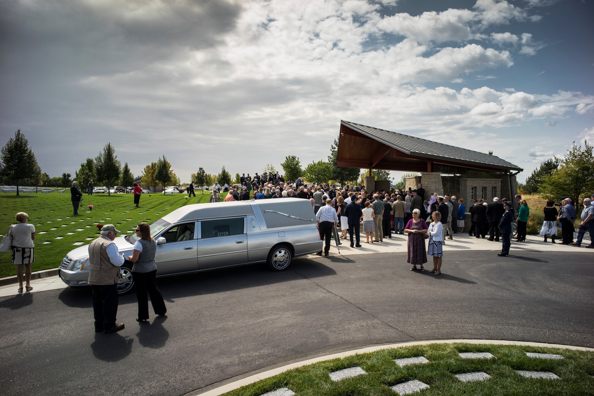 Funeral attendees disperse after honoring Col. (Ret.) Bernard Fisher in his final resting place at Idaho State Veterans Cemetery August 25, 2014, at Boise, Idaho. In 1967, then Maj. Fisher became the first living Air Force Medal of Honor recipient when he was presented the medal at a White House Ceremony by then President Lyndon B. Johnson. (U.S. Air Force photo by Tech. Sgt. Samuel Morse/RELEASED)