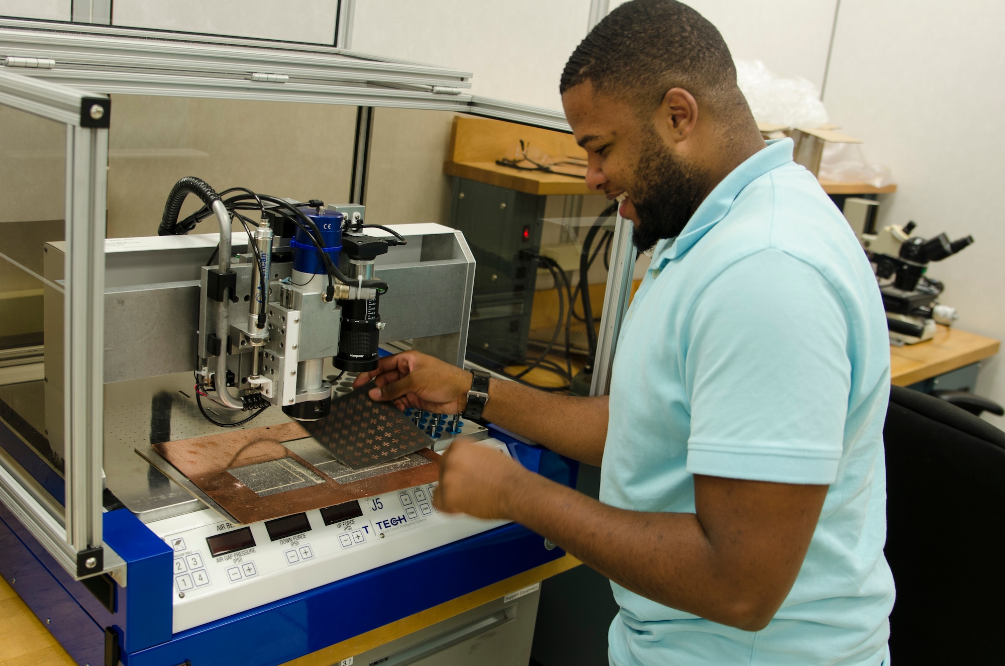 AFRL Thurgood Marshall College Fund (TMCF) intern, Donyai Moffatt, creates copper engraved patterns on a copper plate for use in an antenna measurement system. (Air Force photo/Mikee Huber)