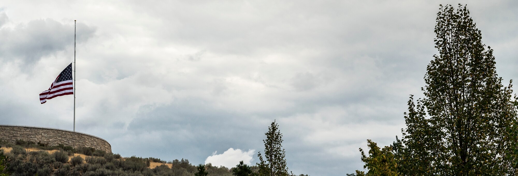 The flag is flown at half staff to signify the loss of Col. (Ret.) Bernard Fisher at Fisher at Idaho State Veterans Cemetery August 25, 2014, at Boise, Idaho. While assigned to the 1st Air Commando Squadron at Pleiku, South Vietnam, he received nationwide publicity for his actions during the battle of A Shau Valley in which he rescued a downed pilot by landing his A-1E Skyraider on a shrapnel-ridden runway and under heavy ground fire. (U.S. Air Force photo by Tech. Sgt. Samuel Morse/RELEASED) 