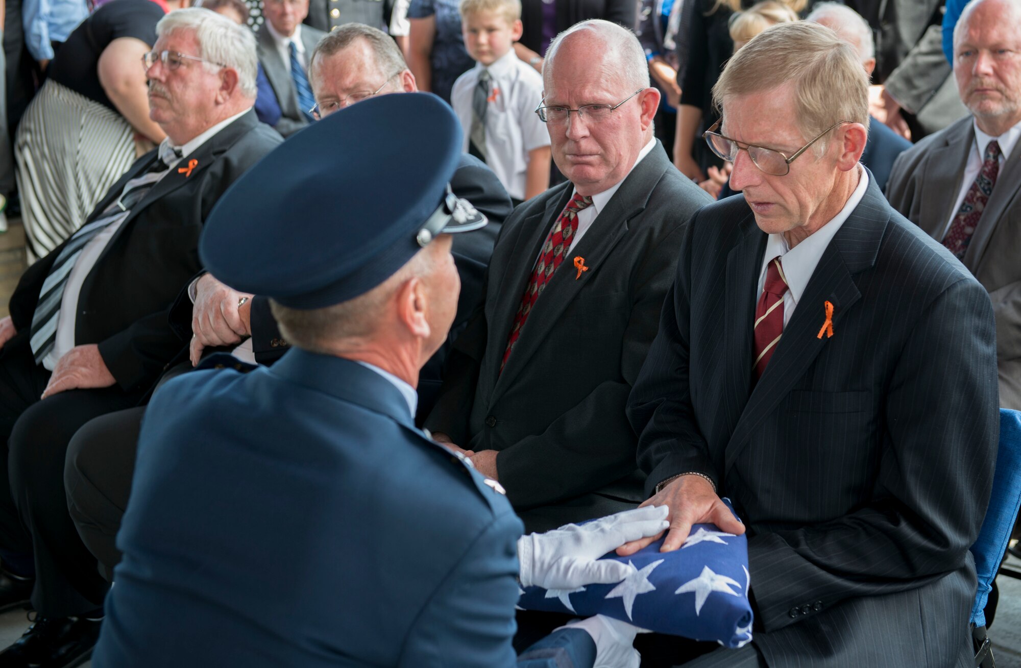 Maj. Gen. Gary Sayler presents the United States flag to Brad Fisher at Idaho State Veterans Cemetery August 25, 2014, at Boise, Idaho. While assigned to the 1st Air Commando Squadron at Pleiku, South Vietnam, he received nationwide publicity for his actions during the battle of A Shau Valley in which he rescued a downed pilot by landing his A-1E Skyraider on a shrapnel-ridden runway and under heavy ground fire. (U.S. Air Force photo by Airman 1st Class Malissa Lott/RELEASED)