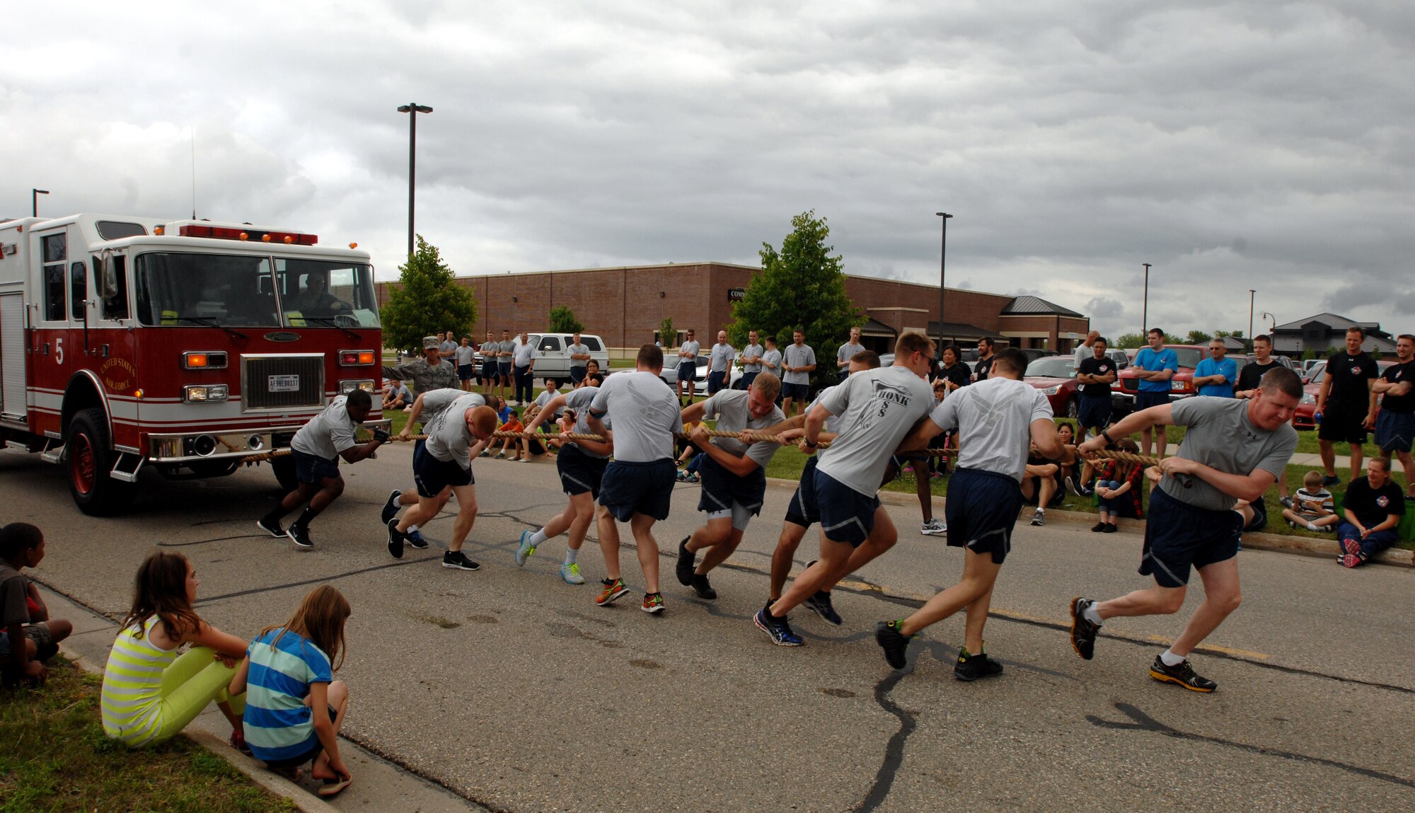 Members of the 319th Operations Support Squadron pull a 22,000-pound fire truck during Summer Bash on Grand Forks Air Force Base, N.D., Aug. 21, 2014. Summer Bash is an annual event designed to boost morale and increase esprit de corps. (U.S. Air Force photo/Staff Sgt. Susan L. Davis)