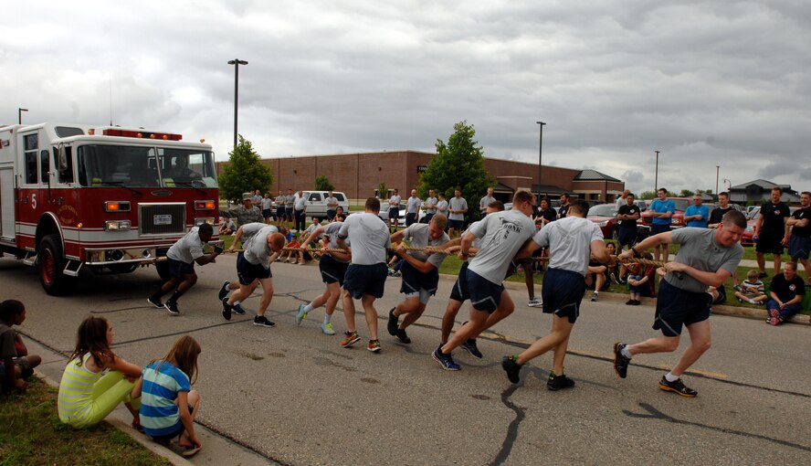 Members of the 319th Operations Support Squadron pull a 22,000-pound fire truck during Summer Bash on Grand Forks Air Force Base, N.D., Aug. 21, 2014. Summer Bash is an annual event designed to boost morale and increase esprit de corps. (U.S. Air Force photo/Staff Sgt. Susan L. Davis)