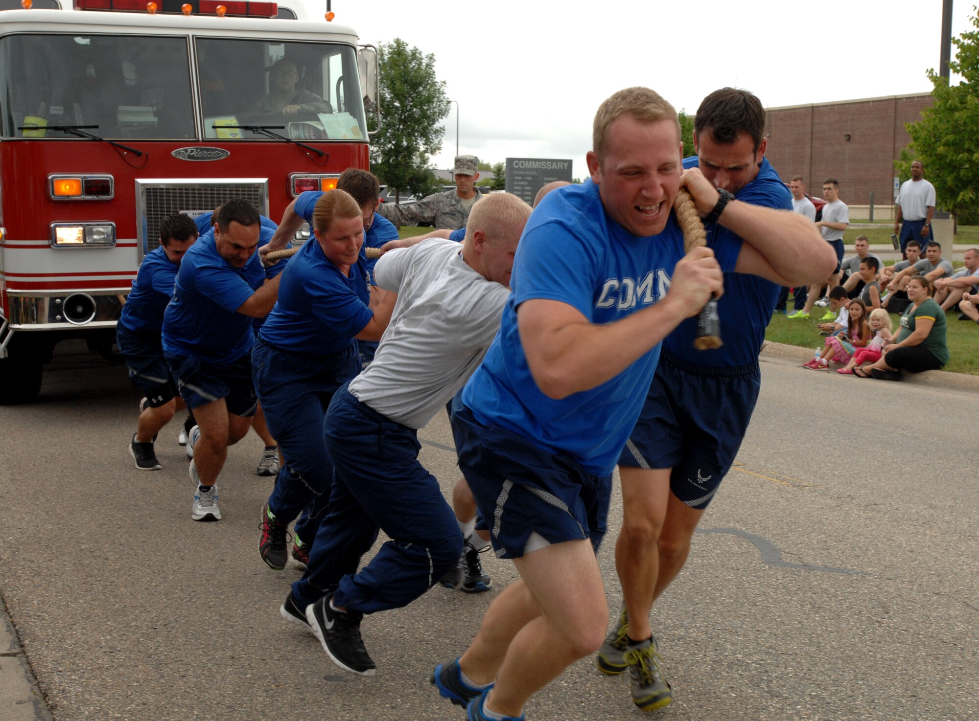 Members of the 319th Communications Squadron pull a 22,000-pound fire truck during Summer Bash on Grand Forks Air Force Base, N.D., Aug. 21, 2014. Summer Bash is an annual event designed to boost morale and increase esprit de corps. (U.S. Air Force photo/Staff Sgt. Susan L. Davis)