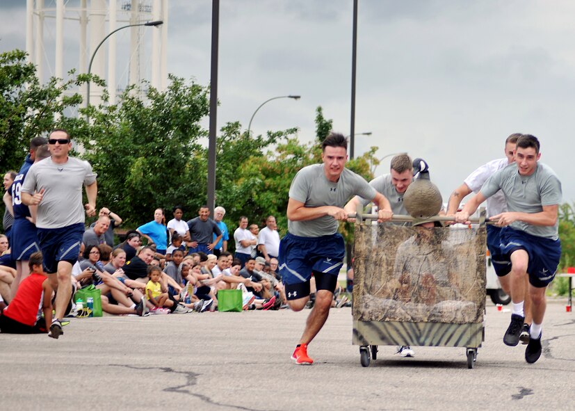 Members of the 319th Operations Support Squadron members sprint toward the finish line during the Summer Bash bed race event Aug. 21, 2014, on Grand Forks Air Force Base, N.D. Summer Bash is an annual event designed to boost morale and increase spirit de corps. (U.S. Air Force photo/Senior Airman Xavier Navarro)