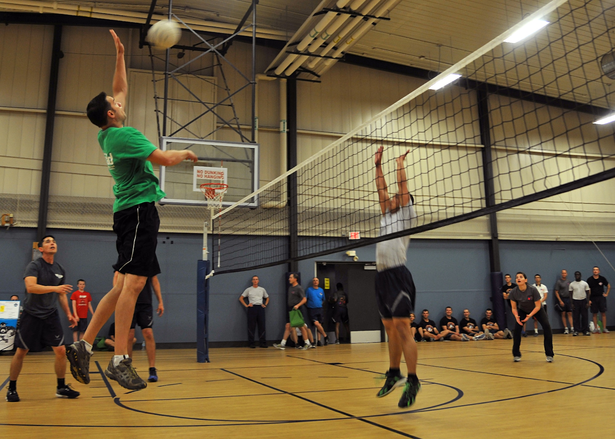 Robert Zafke, 319th Air Base Wing Inspector General Wing Inspection Team member, jumps to spike a ball during the Summer Bash 4-on-4 volleyball tournament Aug. 21, 2014, on Grand Forks Air Force Base, N.D. The volleyball teams played single elimination with each match consisting of one set played to 25 points with rally points scoring. (U.S. Air Force photo/Senior Airman Xavier Navarro)