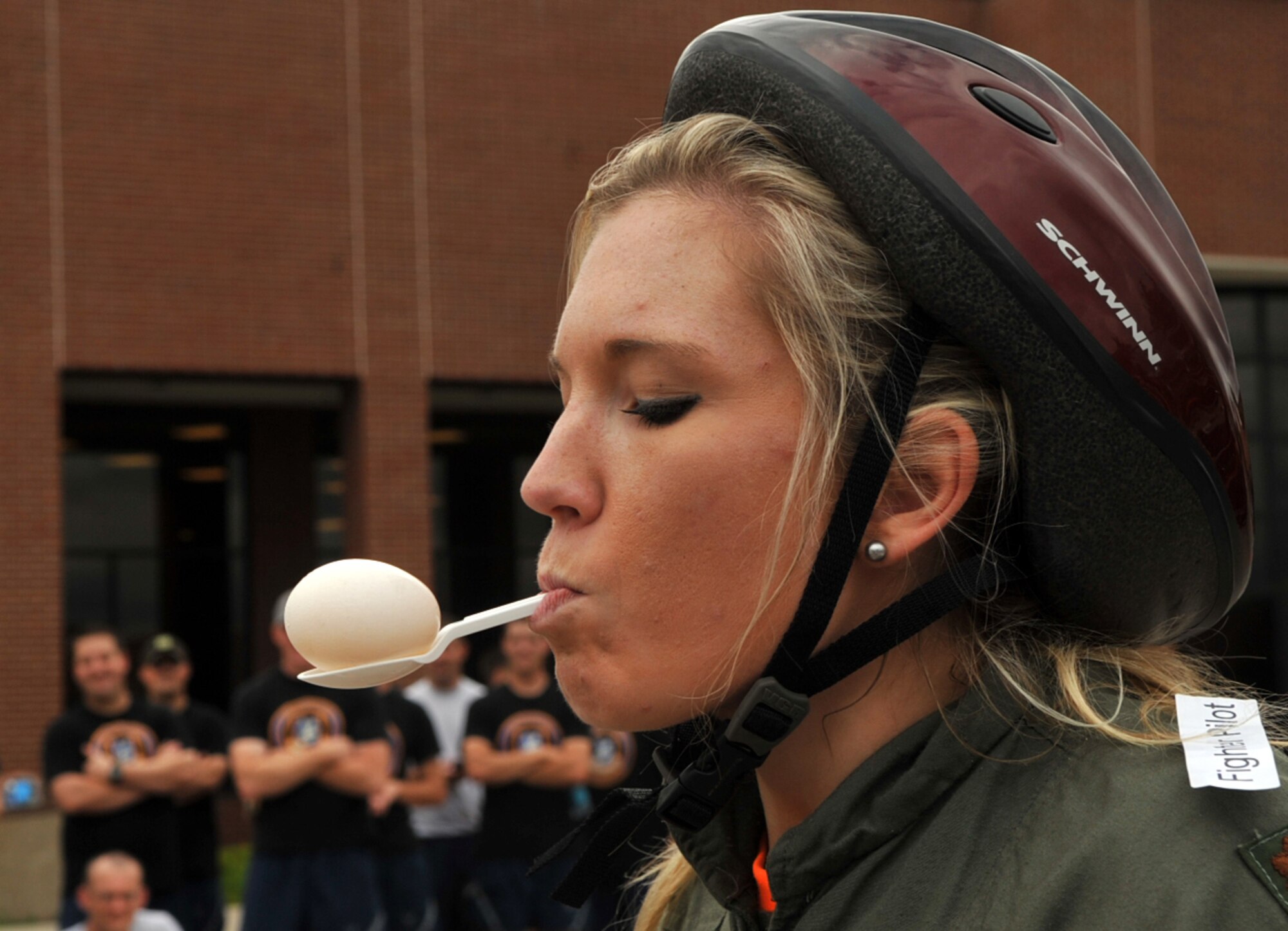 Chelseah Baker, spouse of Staff Sgt. Justin Baker, 319th Contracting Flight contract specialist, carries an egg on a spoon as a part of the bed race challenge held during Summer Bash, Aug. 21, 2014, on Grand Forks Air Force Base, N.D. Summer Bash is an annual event where service members and their families are allowed to participate in a variety of sporting events. (U.S. Air Force photo/Airman 1st Class Bonnie Brewer)