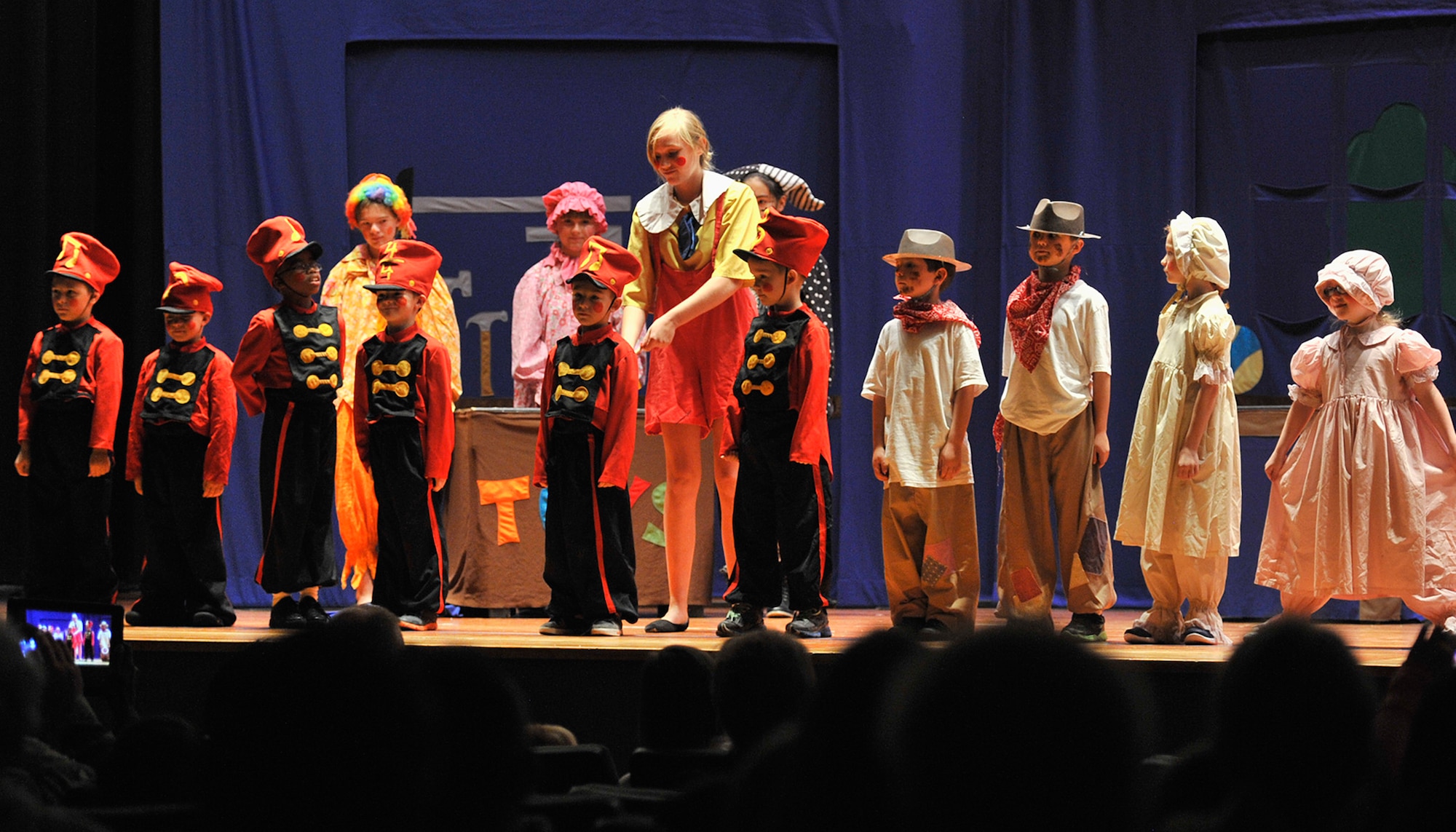Pinocchio (Faith Quinlisk, center) winds up toy soldiers while dolls and puppets become alive in Mrs. Gepetto’s workshop. The play “PINOCCHIO” ran Aug. 22 at the Malmstrom Air Force Base auditorium, and was presented by the 341st Force Support Squadron’s Youth Programs and the Missoula Children’s Theatre. (U.S Air Force photo/John Turner)