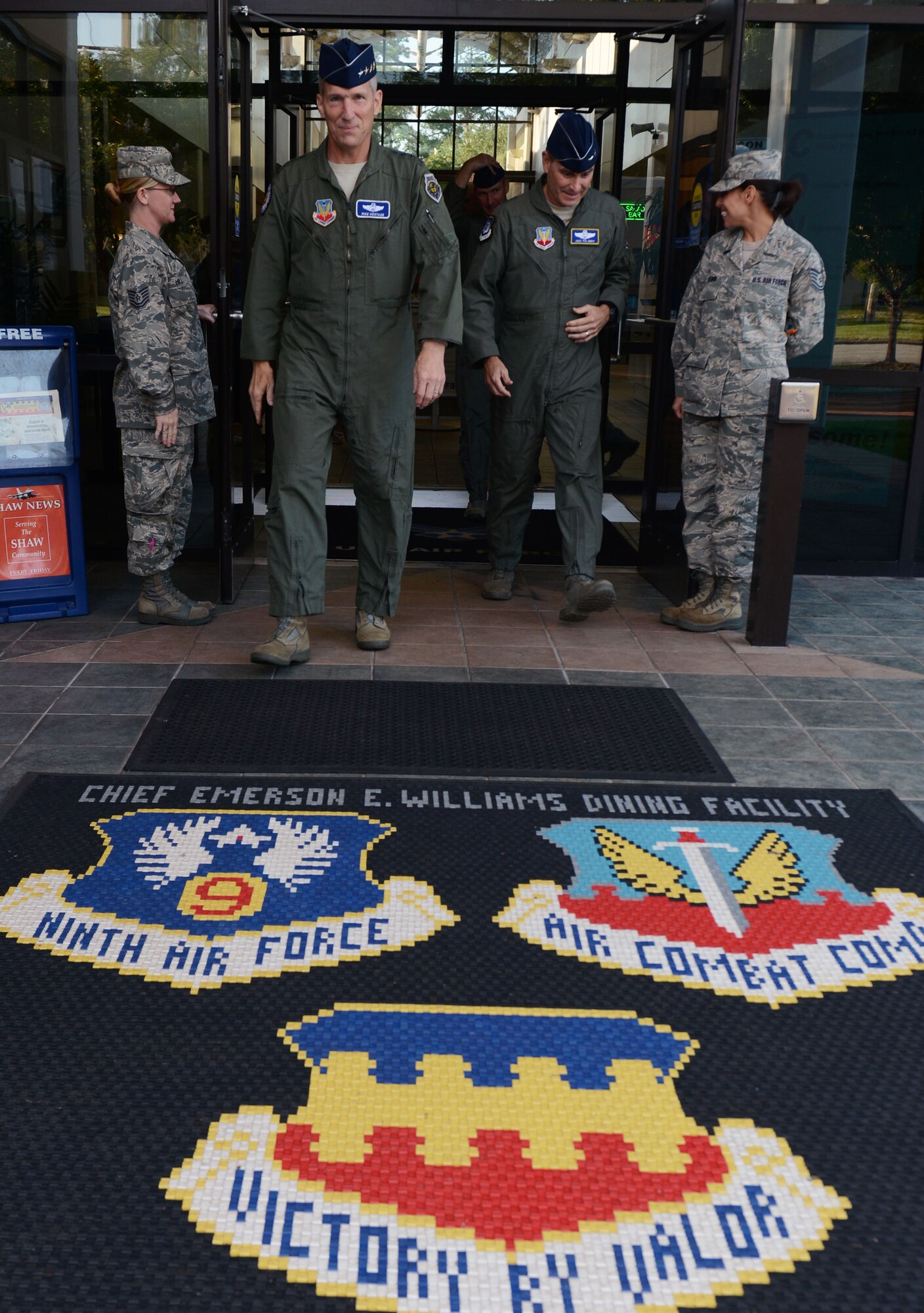 U.S. Air Force Gen. Mike Hostage, commander of Air Combat Command, and Maj. Gen. H.D. Polumbo Jr., Ninth Air Force commander, depart the Chief Master Sgt. Emerson Williams dining facility at Shaw Air Force Base, S.C., Aug. 21, 2014. During a visit to Shaw, Hostage reiterated the mission of ACC; to provide combat airpower to America's warfighters. (U.S. Air Force photo by Senior Airman Tabatha Zarrella/Released)