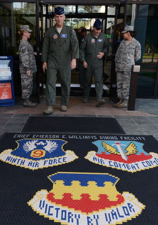 U.S. Air Force Gen. Mike Hostage, commander of Air Combat Command, and Maj. Gen. H.D. Polumbo Jr., Ninth Air Force commander, depart the Chief Master Sgt. Emerson Williams dining facility at Shaw Air Force Base, S.C., Aug. 21, 2014. During a visit to Shaw, Hostage reiterated the mission of ACC; to provide combat airpower to America's warfighters. (U.S. Air Force photo by Senior Airman Tabatha Zarrella/Released)