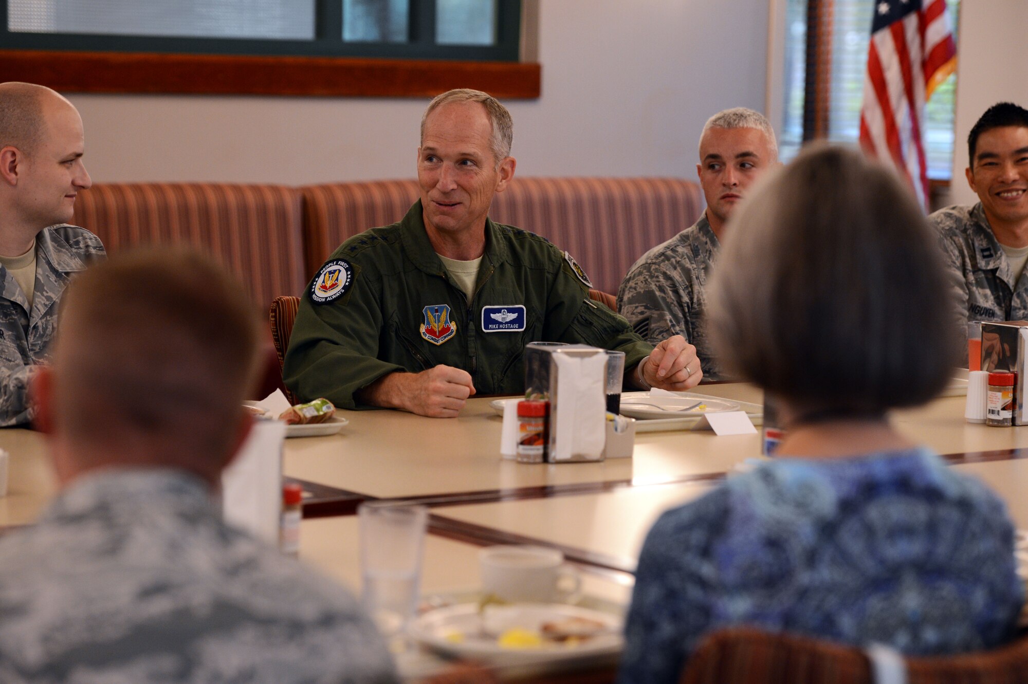 U.S. Air Force Gen. Mike Hostage, commander of Air Combat Command, replies to a question from Tech. Sgt. Frank Miller III, 20th Fighter Wing Public Affairs photojournalist, during breakfast at the Chief Master Sgt. Emerson Williams dining facility at Shaw Air Force Base, S.C., Aug. 21, 2014. Hostage attended the open forum to discuss topics on the minds of Airmen here. (U.S. Air Force photo by Senior Airman Tabatha Zarrella/Released)