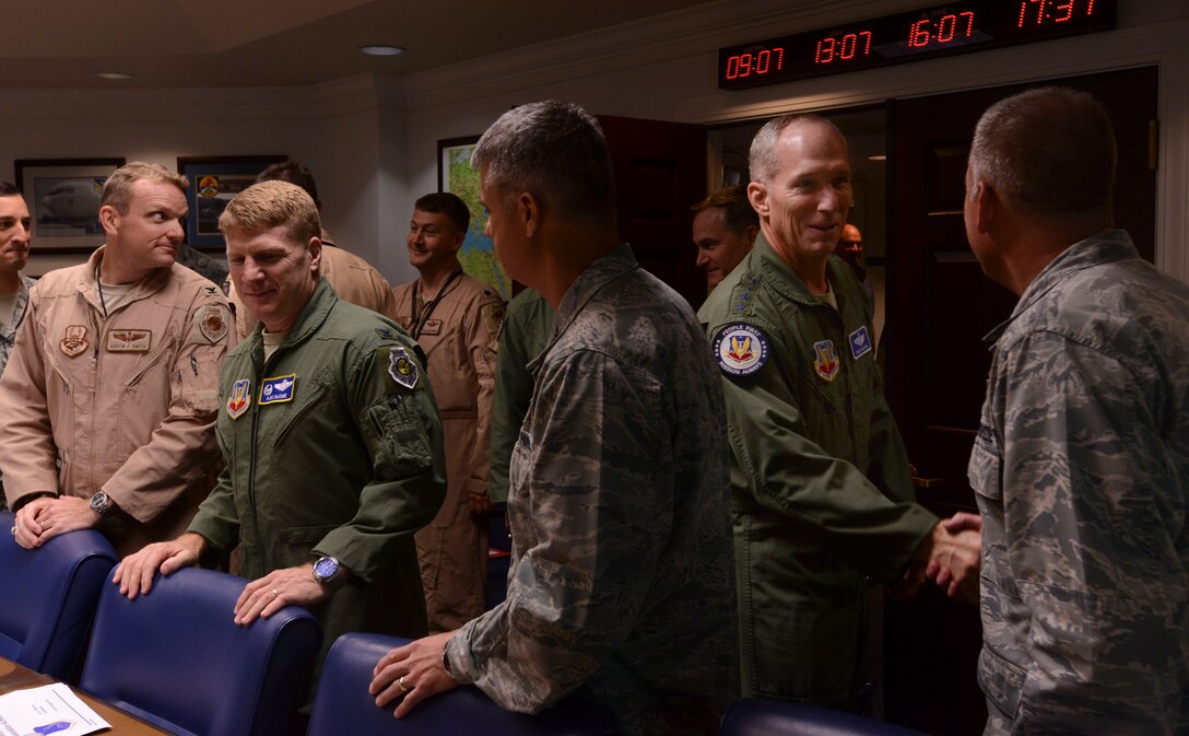 U.S. Air Force Gen. Mike Hostage, commander of Air Combat Command, shakes hands with Team Shaw leaders before a meeting at Shaw Air Force Base, S.C., Aug. 20, 2014. Hostage met with Team Shaw leaders and Airmen to discussion the mission and their concerns during his visit here.  (U.S. Air Force photo by Senior Airman Tabatha Zarrella/Released)