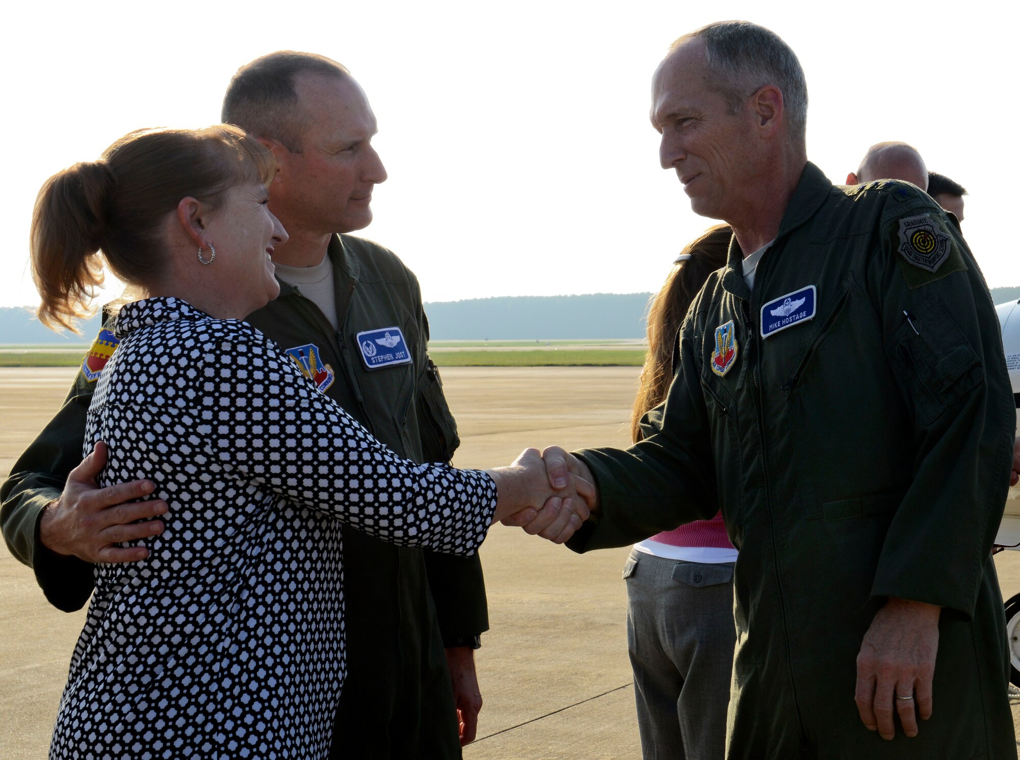 U.S. Air Force Gen. Mike Hostage, commander of Air Combat Command, shakes hands with Kelly Jost, wife of Col. Stephen Jost, 20th Fighter Wing commander here Aug. 20. Hostage met with Team Shaw leaders and Airmen to discussion the mission and their concerns during his visit here.  (U.S. Air Force photo by Senior Airman Tabatha Zarrella/Released)
