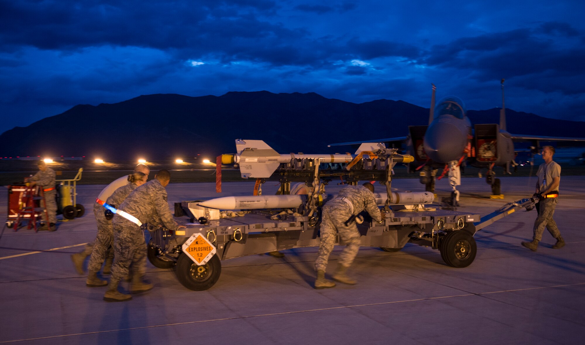 U.S. Air Force Airmen push a missile to an F-15 Eagle on Hill Air Force Base, Utah, Aug. 20, 2014. The F-15 is from Royal Air Force Lakenheath, England, and was on Hill Air Force Base as part of a Weapon System Evaluation Program in conjunction with F-16 Fighting Falcons from Aviano Air Base, Italy. (U.S. Air Force photo by Airman 1st Class Joshua King/Released)