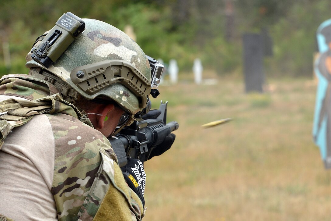 Captain Nathan Maxton, 3rd Air Support Operations Squadron tactical air control party member, fires at a moving target Aug. 20, 2014, during the Cascade Challenge at Range 103 next to North Fort Lewis at Joint Base Lewis-McChord, Wash. The participants shot the Colt M-4 carbine assault rifle and the Beretta M-9 pistol and were graded on their time of completion, and the amount of times they hit the target. (U.S. Air Force photo/Airman 1st Class Keoni Chavarria)