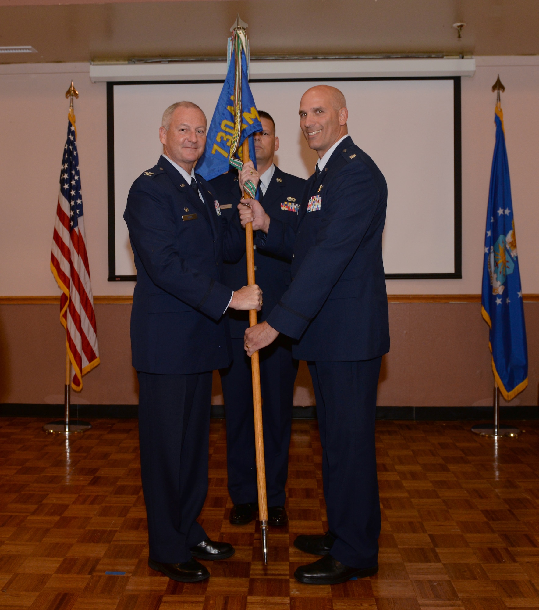 ALTUS AIR FORCE BASE, Okla. -- Colonel Brian Davis (left) hands off the 730th Air Mobility Training Squadron guidon to Lt. Col. Michael Remualdo as he assumes command of unit during the August Unit Training Assembly.  The 730th AMTS was transferred to the 507th Operations Group, 507th Air Refueling Wing, Tinker Air Force Base, Okla. in July. (Courtesy Photo)  
