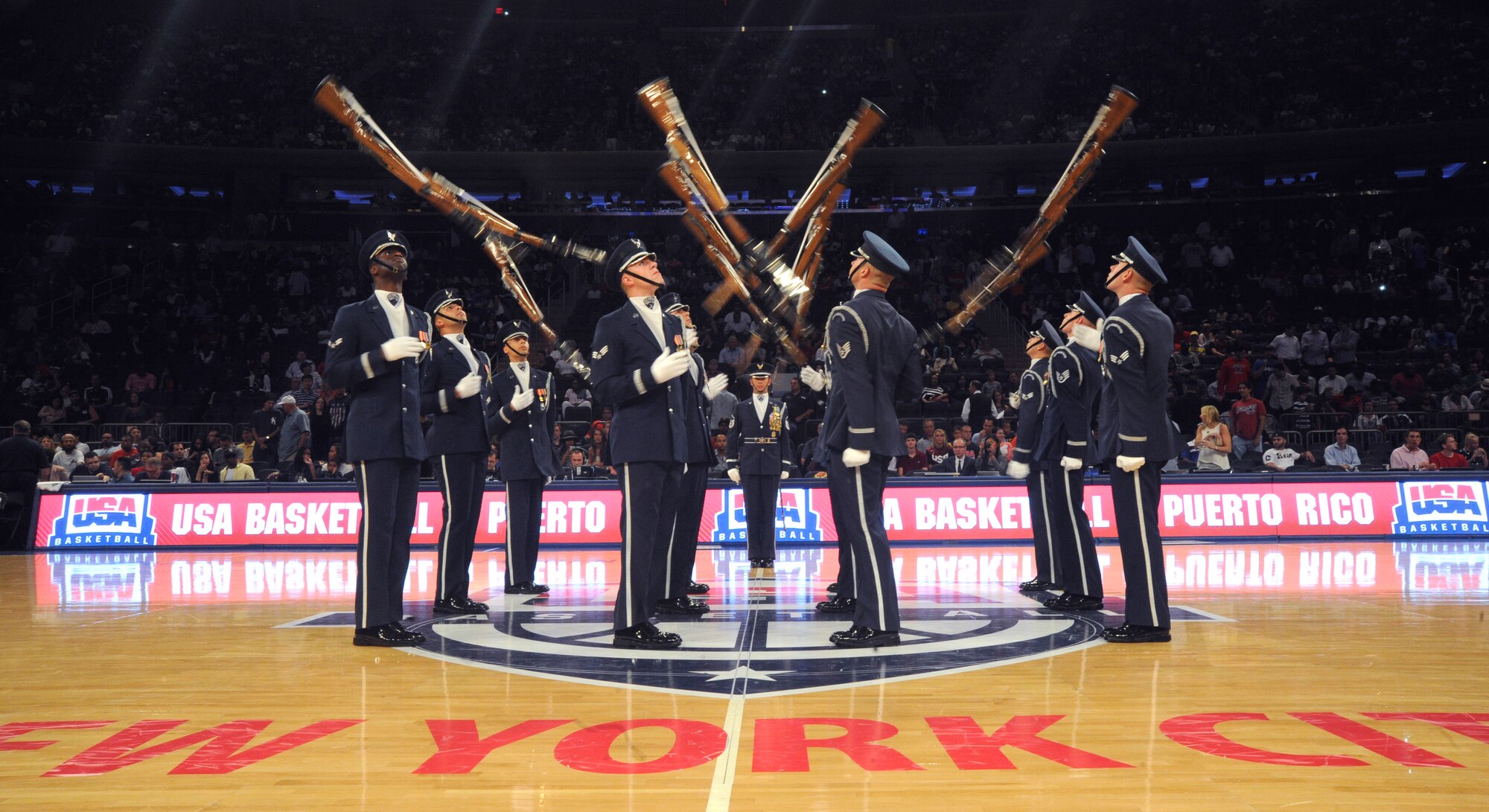 The United States Air Force Honor Guard Drill Team tosses their M-1 rifles during a performance at the USA Men’s National Basketball Team game against Puerto Rico at Madison Square Garden, New York, August 22, 2014. The Drill Team promotes the Air Force mission by showcasing drill performances at public and military venues to recruit, retain and inspire Airmen. (U.S. Air Force photo/Airman 1st Class Ryan J. Sonnier)