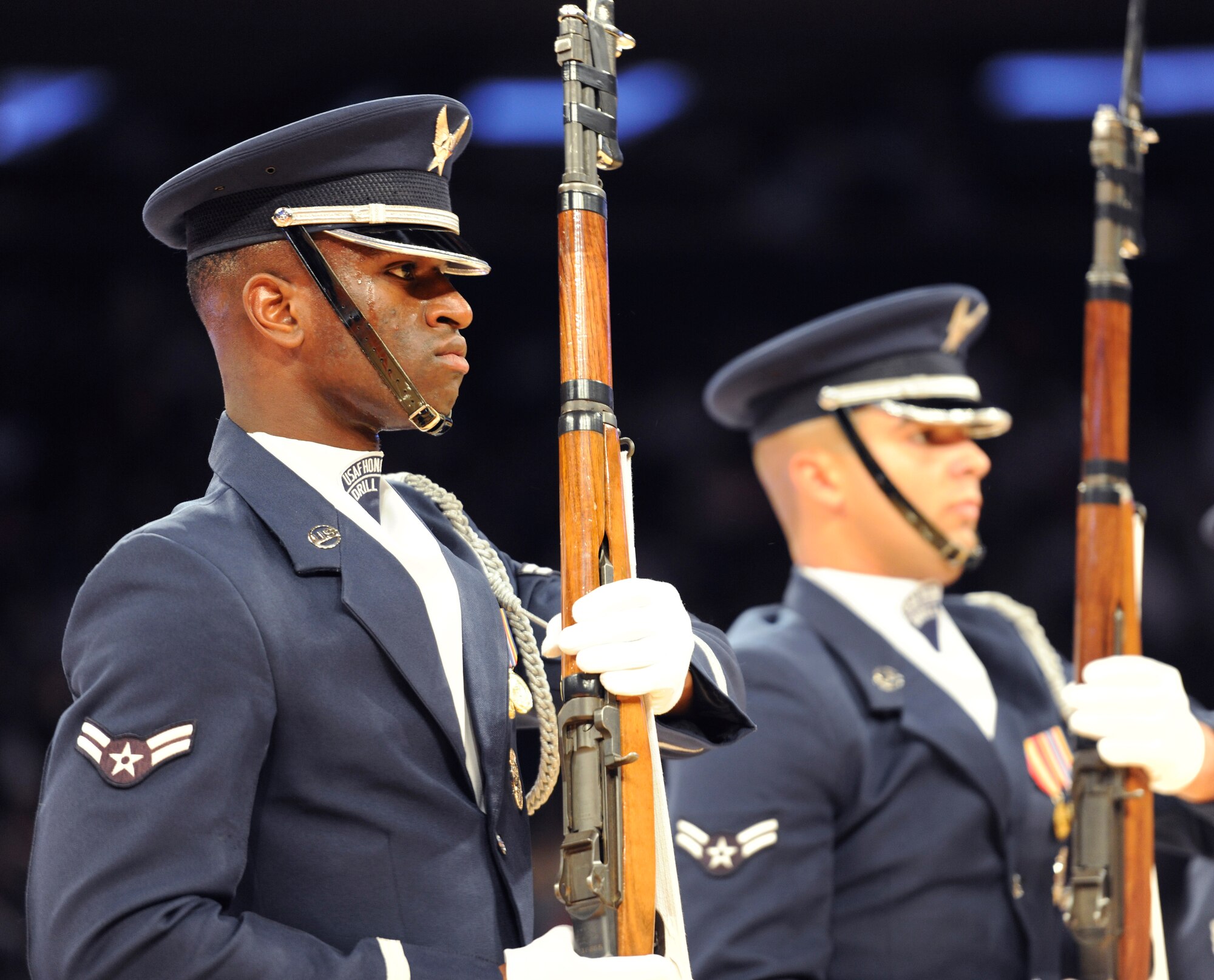 Airman 1st Class Omari Ferguson, a United States Air Force Honor Guard Drill Team member, performs a maneuver during a halftime show at Madison Square Garden, New York, August 22, 2014. The Drill Team promotes the Air Force mission by showcasing drill performances at public and military venues to recruit, retain and inspire Airmen. (U.S. Air Force photo/Airman 1st Class Ryan J. Sonnier)